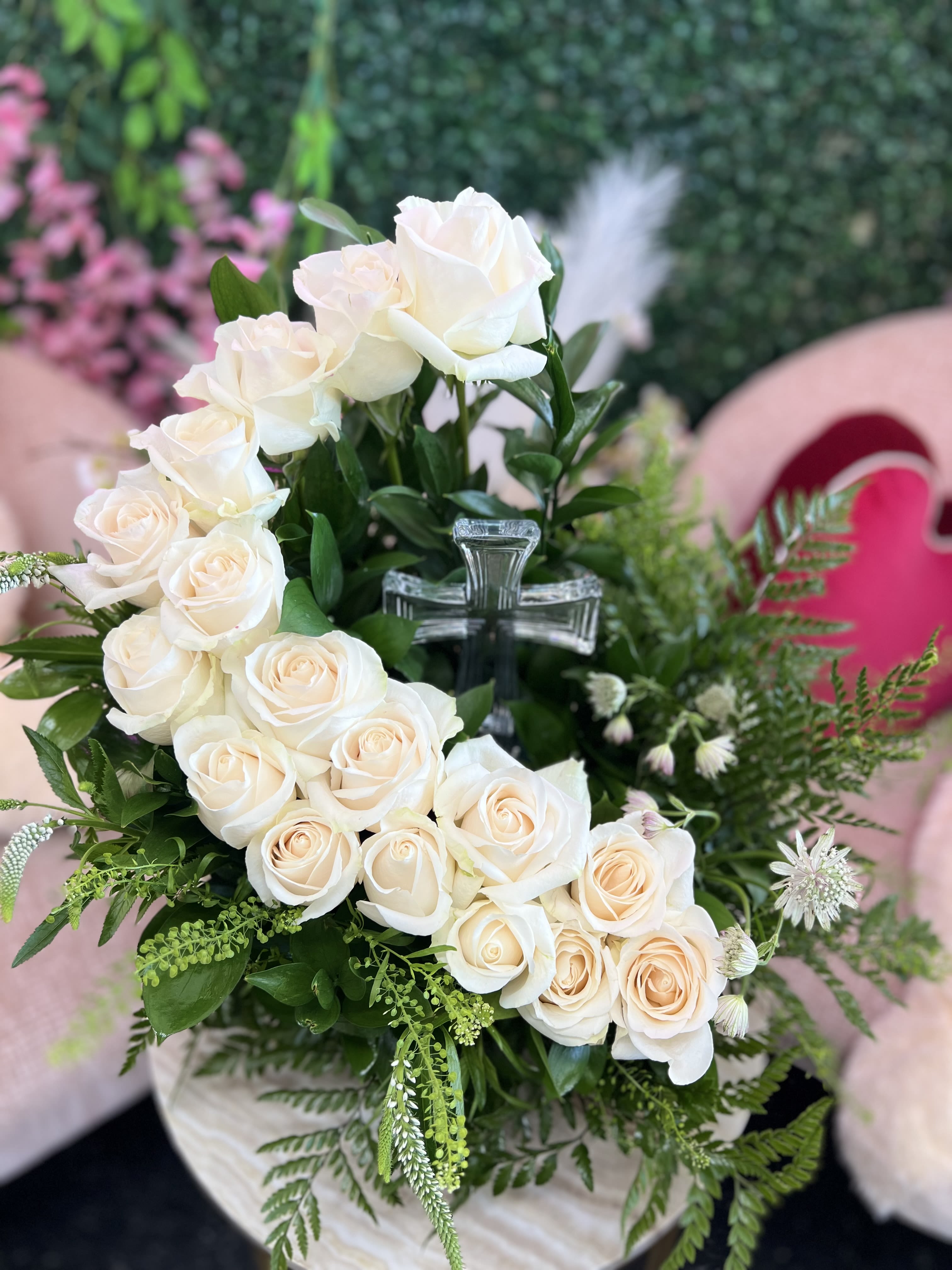  Heavenly Rose Tribute with Crystal Cross - Honor your loved one with grace and beauty. The Heavenly Rose Tribute features a lush bed of premium roses, delicately arranged to surround a keepsake crystal cross. This elegant design symbolizes peace, faith, and eternal love, offering comfort and a meaningful way to remember someone special. Ideal for services, memorials, or graveside tributes.