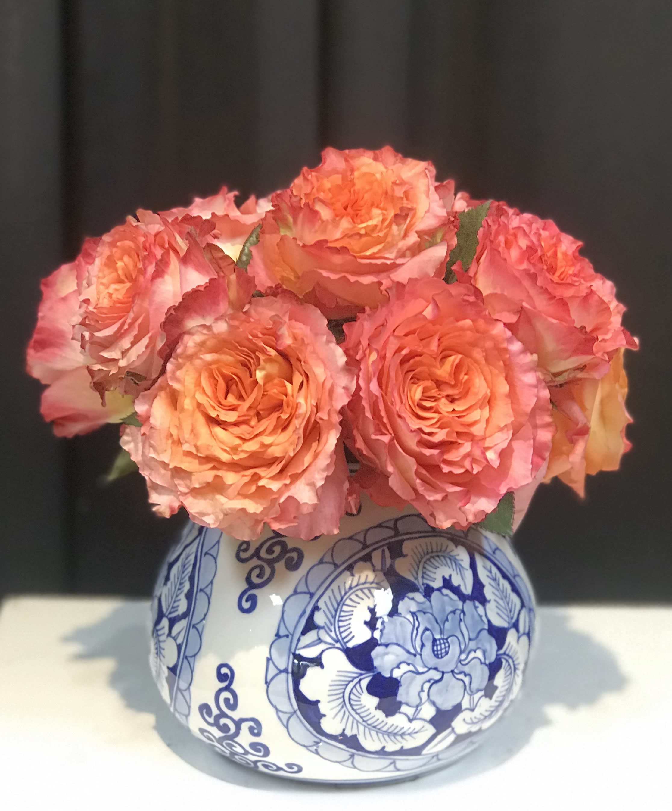 Opal Opal - In a classic blue and white Chinoiserie vase, low and tight bold colored roses what really make a statement for that special someone... and you can enjoy the vase for years to come!