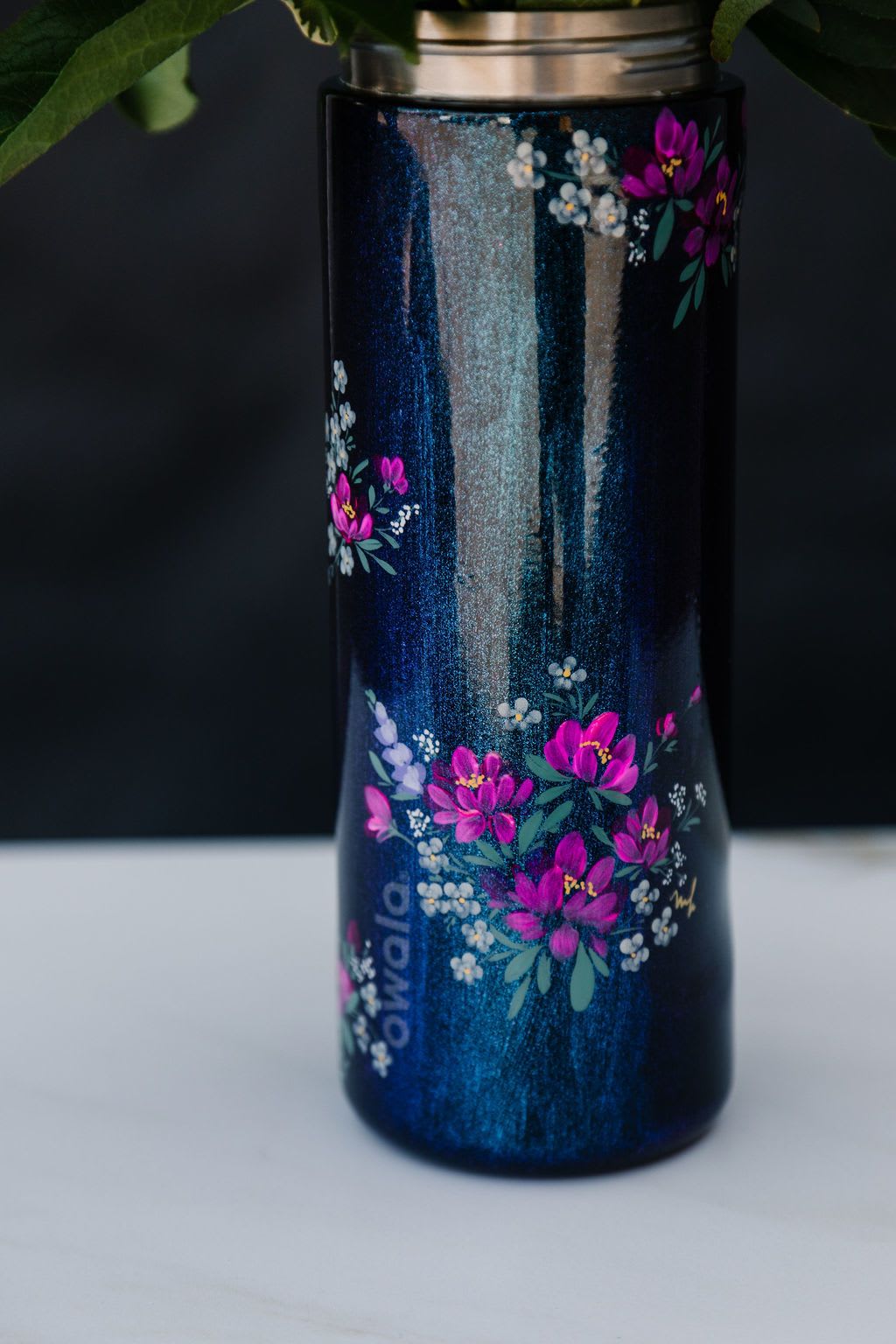 Midnight Blossom (Tumbler Only) Midnight Blossom (Tumbler Only) - Order Now! Each tumbler is a one-of-a-kind, hand-painted piece sealed with a clear gloss powder coat—dishwasher safe, chip-resistant, and made to last; by artist Melanie Haggard @meligrafi. Want the tumbler with flowers? Just click the “Occasions” tab at the top of the page and scroll to Summer.