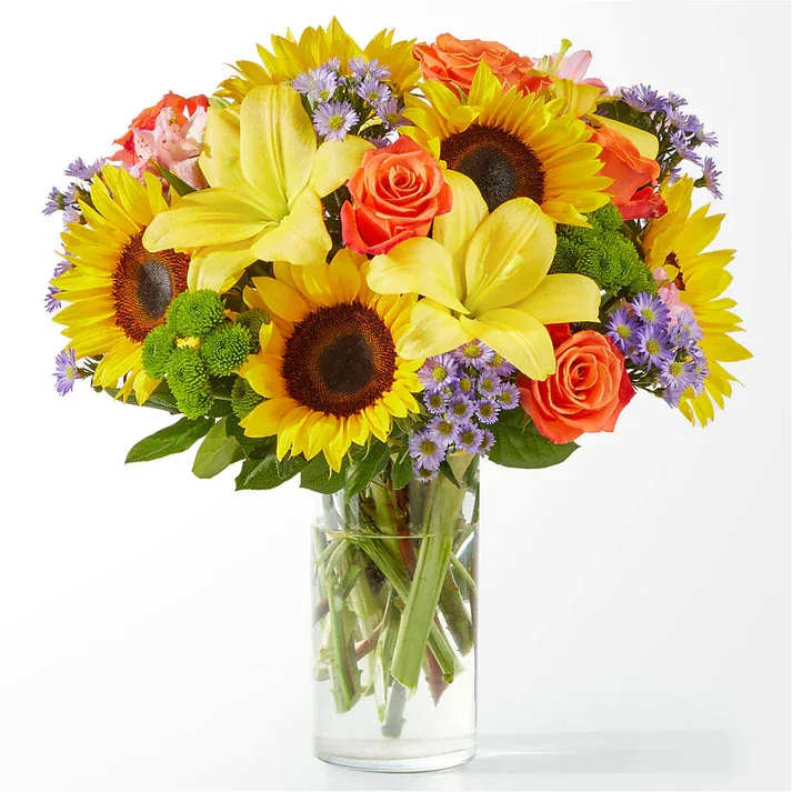 Basking in the Glow Bouquet (exquisite) Basking in the Glow Bouquet (exquisite) - Feel the warmth with this radiant arrangement, full of sunny sunflowers, lilies and roses. This colorfully charismatic bouquet will have your recipient glowing from the inside out. Details The Exquisite Bouquet is approximately 17"H x 17"W. Designed by florists, ready to display. For long–lasting blooms, replace the water daily. We suggest trimming the stems every couple days. Pet Safety Precautions: This bouquet or plant may include flowers and foliage that are known to be toxic to pets. To keep them safe, be sure to keep this arrangement out of your pet's reach.