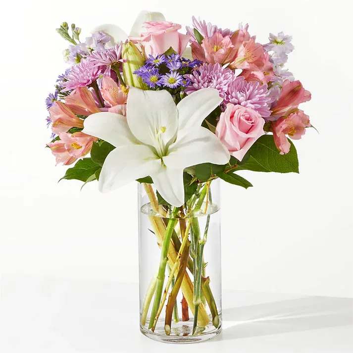 Weekend Escape Bouquet - Momentarily step away from the everyday by taking a deep breath of these blushing lilies, roses, and stock. Whether you are celebrating, cheering up, or simply saying “I miss you,” these pastel florals will make their day. Details The Deluxe Bouquet is approximately 15&quot;H x 13&quot;W. Designed by florists, ready to display. For long–lasting blooms, replace the water daily. We suggest trimming the stems every couple days. Pet Safety Precautions: This bouquet or plant may include flowers and foliage that are known to be toxic to pets. To keep them safe, be sure to keep this arrangement out of your pet's reach.