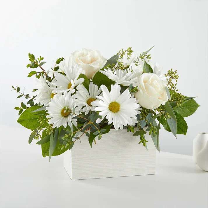 Fresh Linen Box Bouquet  - Create a serene and timeless atmosphere with our Fresh Linen Box Bouquet featuring roses, daisies, and eucalyptus. Details The Deluxe Bouquet is approximately 14&quot;H x 15&quot;W. Designed by florists, ready to display. For long–lasting blooms, replace the water daily. We suggest trimming the stems every couple days. Pet Safety Precautions: This bouquet or plant may include flowers and foliage that are known to be toxic to pets. To keep them safe, be sure to keep this arrangement out of your pet's reach.