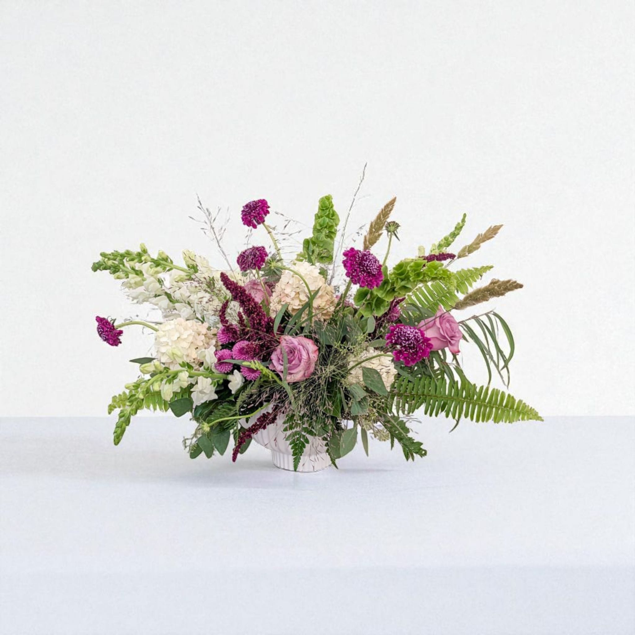 Adam Adam - Adam is composed, grounded, and just a little wild. With soft whites, moody plum, and textured greens — it's all about quiet strength and subtle charm. (Also… named after one of our favorite regulars — let's see if he catches it )