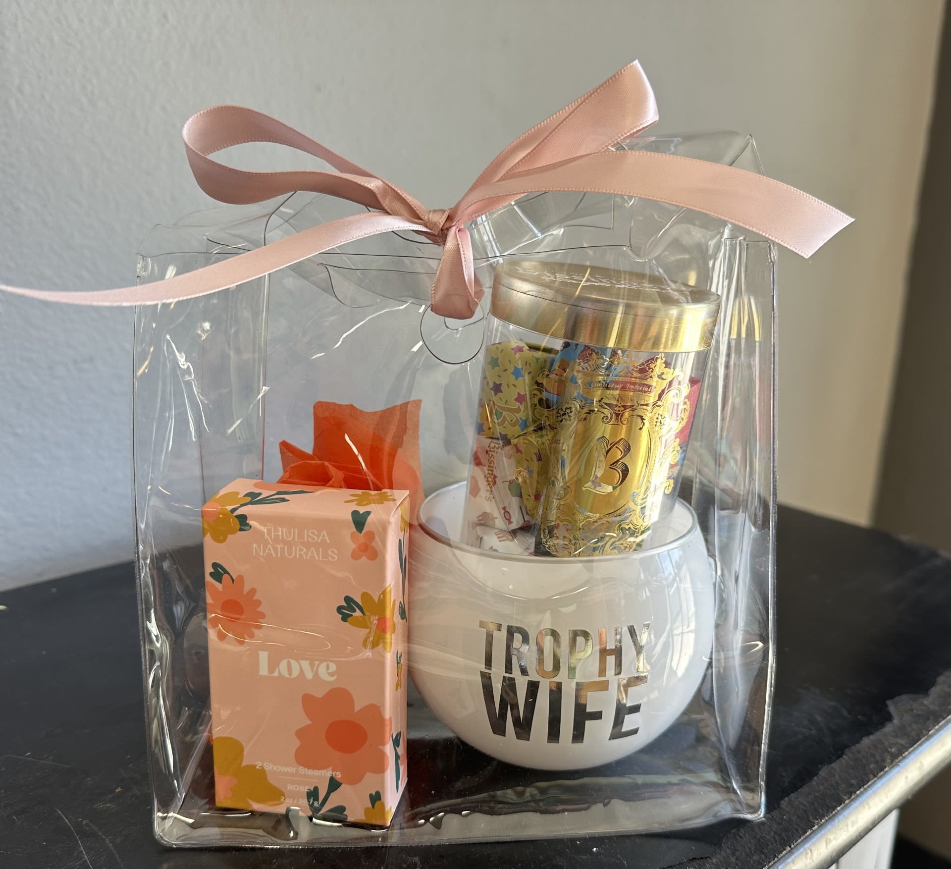 trophy wife mug + birthday gift wrapped chocolates + shower steamer goodie bag - A cute (and funny) goodie bag to add on to any our flower arrangements or plants. Comes with a trophy wife mug, Bissinger's gift wrapped chocolates, and scenty shower steamer. Comes tied off in a small clear handbag with pink ribbon. 