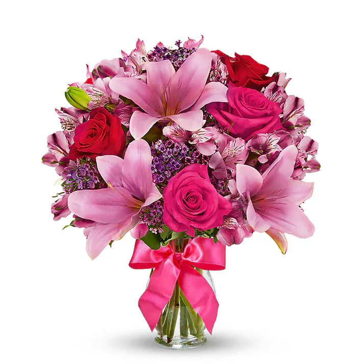 Rose &amp; Lily Celebration  - Send stunning flowers to celebrate any occasion! With classic floral colors including red roses and pink lilies, the Rose and Lily Joy is a wonderful gift to send to a friend or family member for a birthday, get well or anniversary. The flowers are arranged by hand at a local florist shop. The floral artist creates the Rose and Lily bouquet with red roses, pink roses, pink lilies, pink alstroemeria and purple waxflower. Paired with the flowers is a keepsake clear vase that is wrapped in a decorative ribbon. Details The Deluxe Bouquet is approximately 14&quot;H x 12&quot;L. Designed by florists, ready to display. Pet Safety Precautions: This bouquet or plant may include flowers and foliage that are known to be toxic to pets. To keep them safe, be sure to keep this arrangement out of your pet's reach.