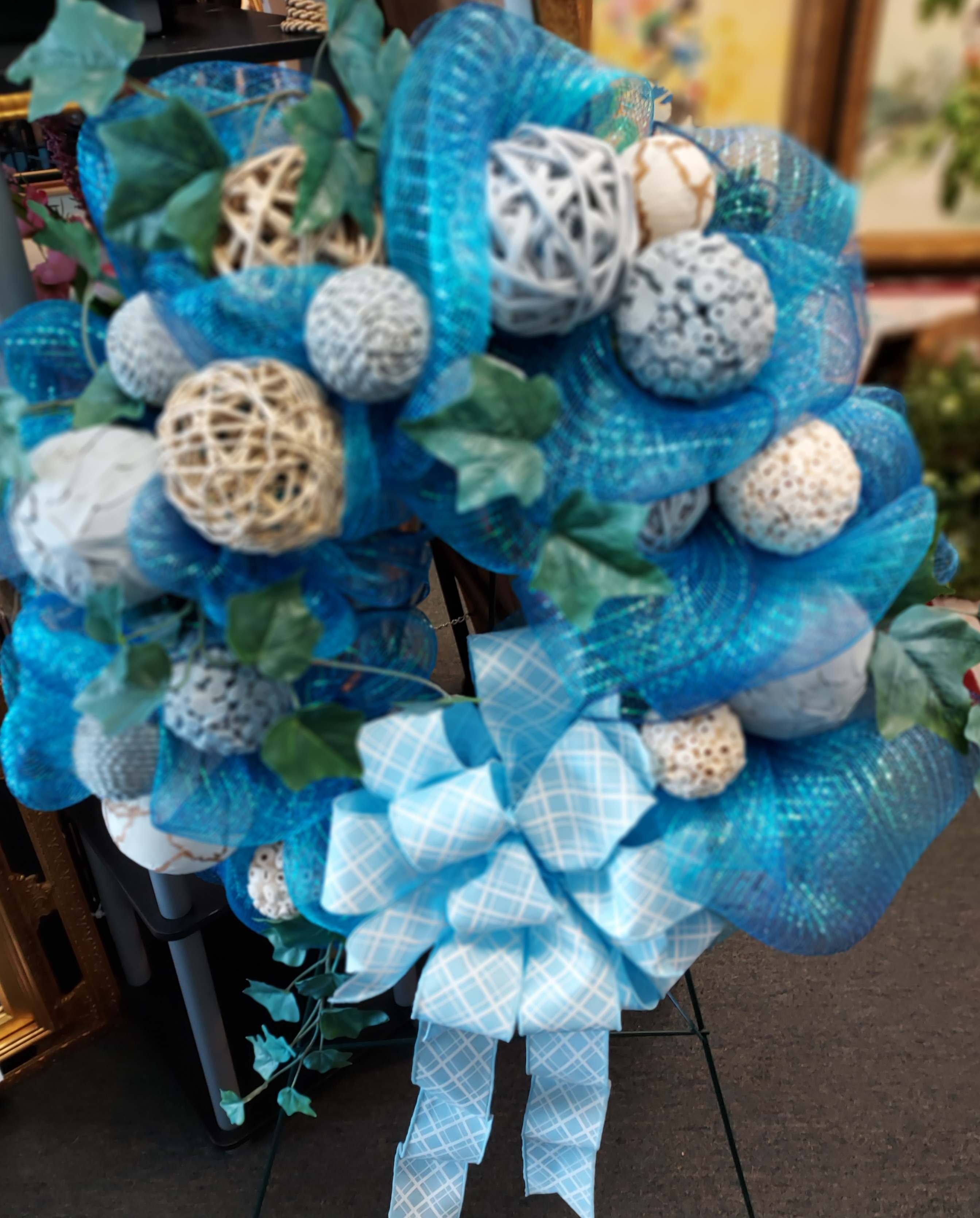 Aqua Blue Mesh Wreath Aqua Blue Mesh Wreath - 22" nylon mesh wreath adorned with orbs to help give the feeling of the ocean. These are totally customizable just call us and let us know what you would like to send. 843-651-1313 At least 24 hours advance notice required.