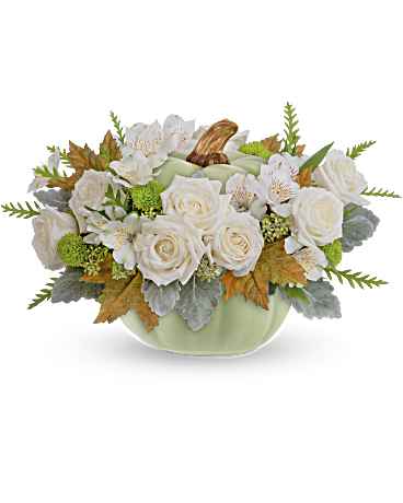 Teleflora's Serenity Sage Bouquet - Ideal for your autumnal table setting, this sophisticated rose arrangement exudes elegance. It is beautifully showcased in a striking ceramic sage pumpkin centerpiece adorned with captivating reactive glaze details. This Serenity Sage Bouquet features graceful white roses, pristine white alstroemeria, fresh green button spray chrysanthemums, and accents of seeded eucalyptus, dusty miller, and grevillea foliage. Delivered in the Sage Harvest Pumpkin, it embodies a perfect blend of natural beauty and rustic charm.