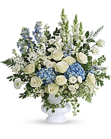 Treasured And Beloved Bouquet - A treasured tribute to your beloved, this gorgeously grand bouquet of soft blue hydrangea and pure white roses is reminiscent of a clear sky, a hopeful reminder of life and love. This beautiful bouquet of light blue hydrangea, white roses, white spray roses, white lisianthus, light blue delphinium, white snapdragons, white stock, and white waxflower is accented with huckleberry, variegated ivy, spiral eucalyptus, dagger fern, and lemon leaf. Delivered in a white designer urn.