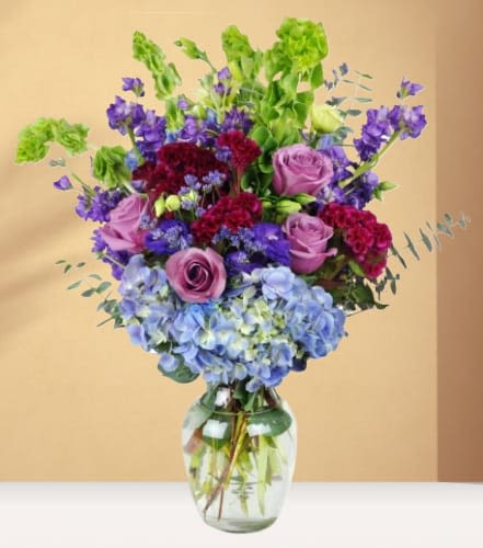 Falling in Love Falling in Love - Gotta jet! Take them on a luxury with a modern take on a classic design. This show-stopping bouquet is sure to impress. A lavish mix of roses, lisianthus, and hydrangea - this captivating arrangement is guaranteed to blow them away.