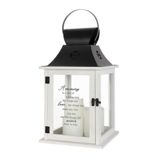 Lantern - 'A Memory' (Black top) - Lantern 'A memory is a way of holding onto the things you love, the things that make you who you are, and the things you never want to lose. Flameless LED candle lantern made from quality wood with metal top. Built-in 3 pillar candles. Automatic timer, 6hrs ON/18hrs OFF. 6 AAA batteries included. Indoor use only. 57468 Approximately 9&quot;W x 18&quot;H