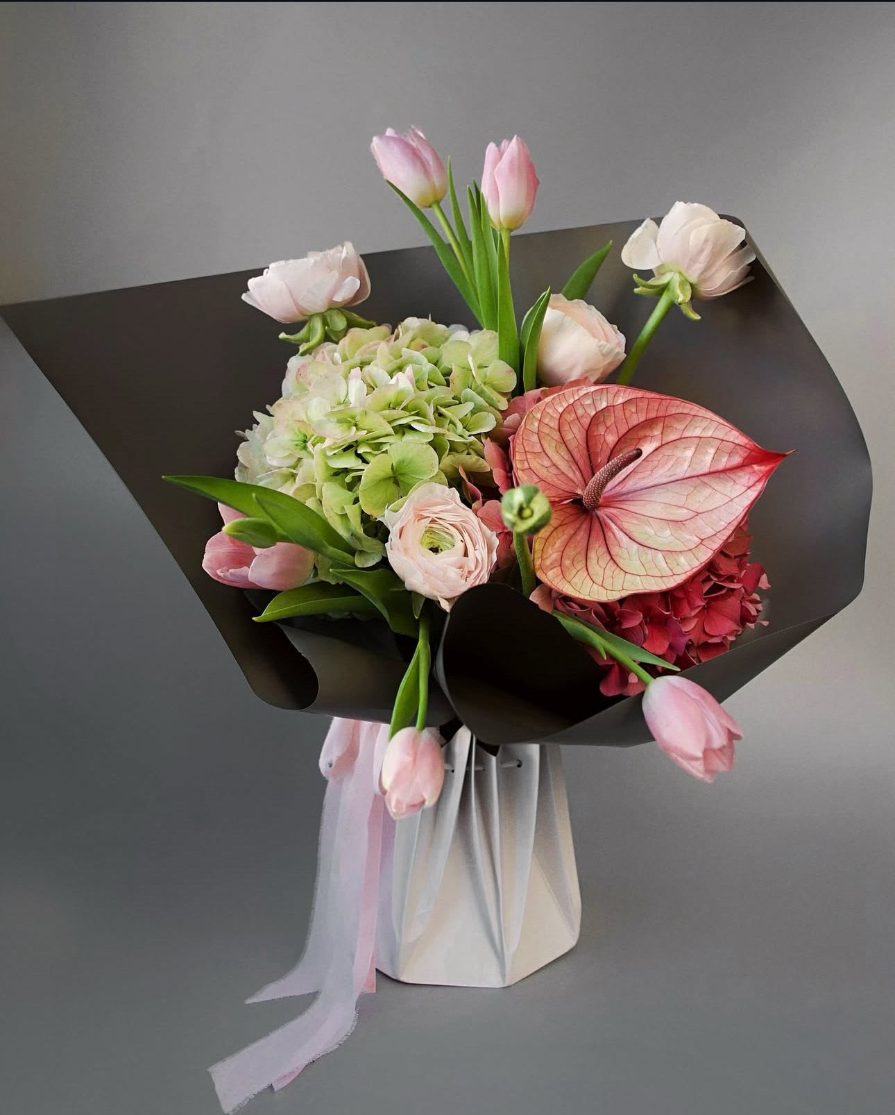 Pink Pistachio - A romantic bouquet in soft pink tones with sculptural heart-shaped blooms — a perfect gesture of love, femininity, and quiet luxury. Some blooms may vary depending on the season, but the signature pink palette and elegant composition will always remain true to the original design.