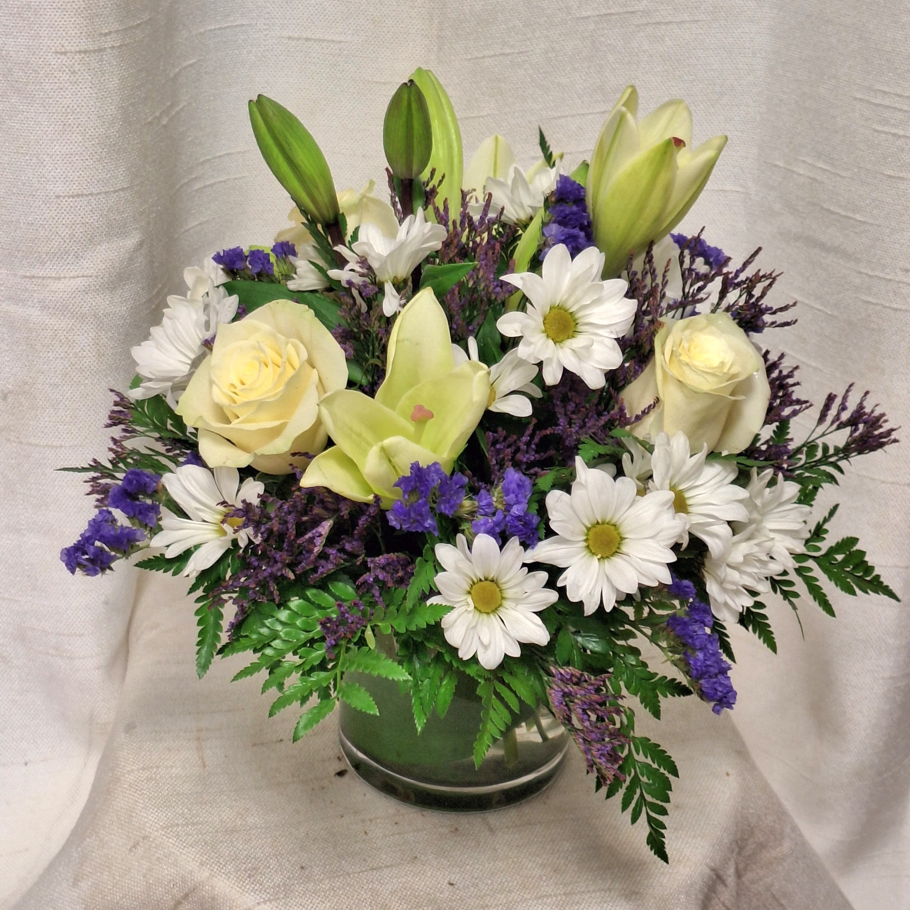 Azure Dream (BB) - There is something about the shade of blue that brings a sense of calmness and serenity. Our Azure Dream bouquet is designed with billowing white blooms and pops of bold florals to deliver just the right sentiment for any reason.