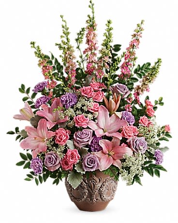 Soft Blush Bouquet - A touching tribute to a beloved woman, this beautiful, soft pink and lavender arrangement is presented in a large antiqued pot for an elegant touch.  This soft pink arrangement features lavender roses, pink spray roses, pink asiatic lilies, lavender carnations, pink larkspur, queen anne's lace, huckleberry, dusty miller, and leatherleaf fern. Delivered in a Classical Garlands pot. Approximately 24&quot; W x 29&quot; H