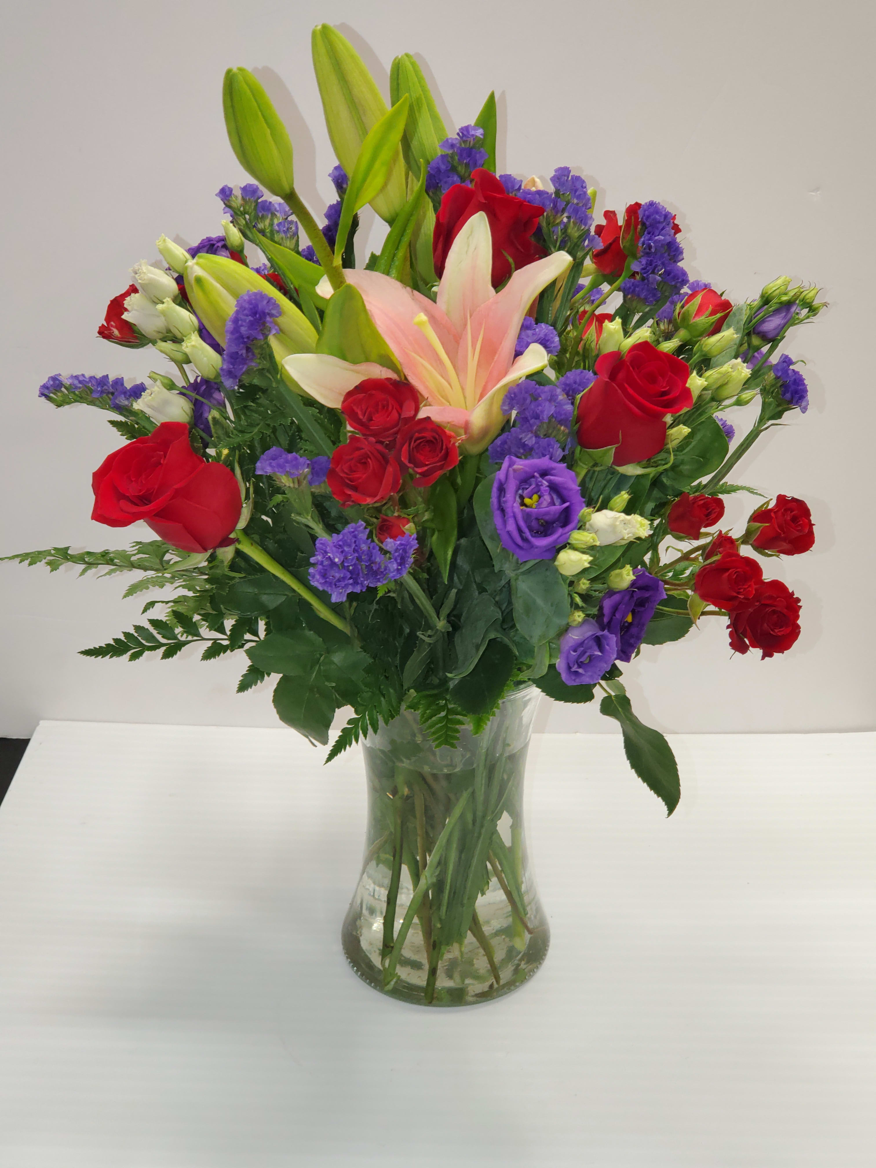Truly Stunning bouquet by Manny Truly Stunning bouquet by Manny - Red and purple flowers a very passionate flowers mix in a clear vase