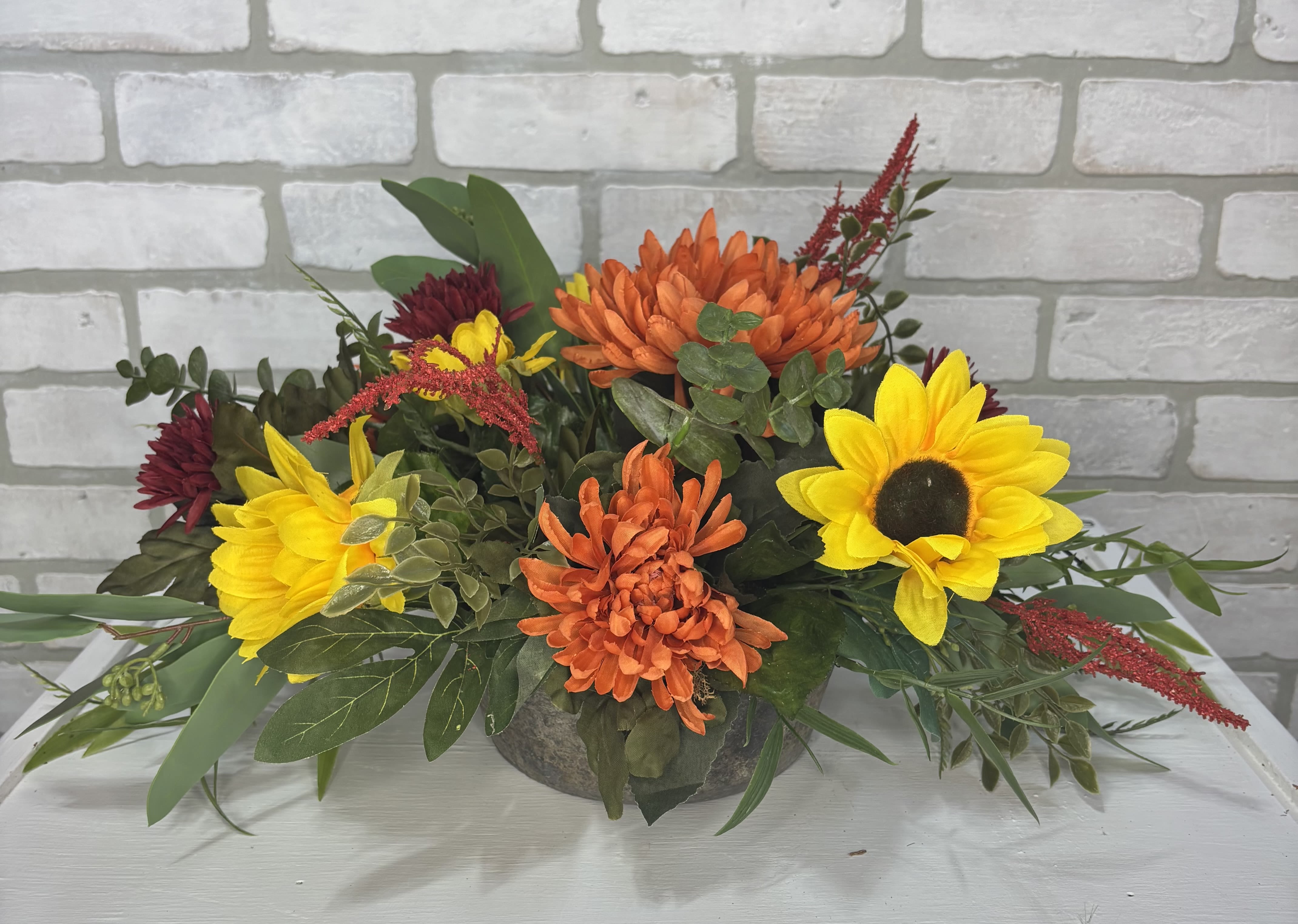 Artificial Silk Fall Center Piece Artificial Silk Fall Center Piece - A concrete bowl arranged with artificial dalilah's, sunflowers, amaranthus, and mixed greens.