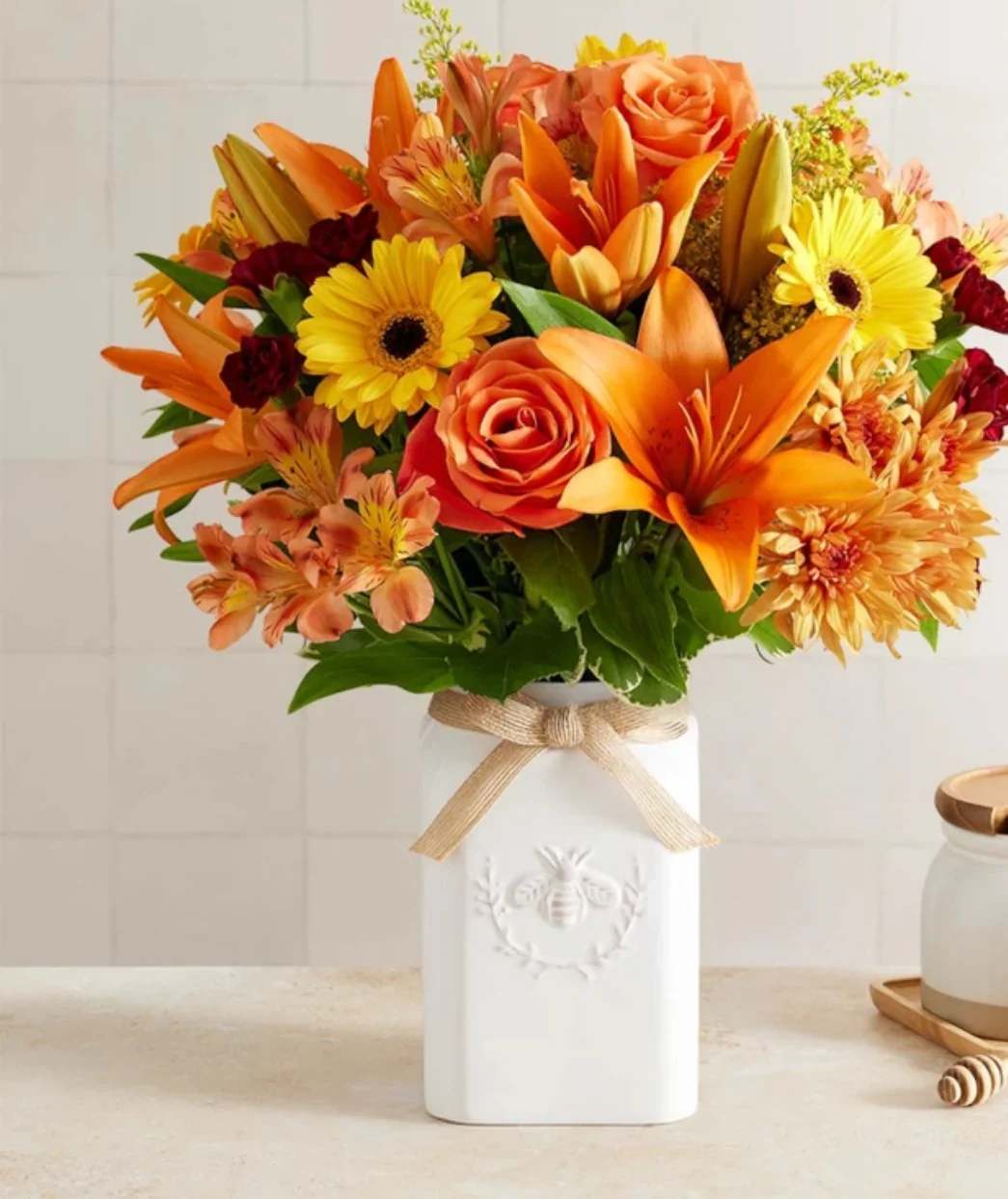 Honey Buzz for Fall (extra exquisite) Honey Buzz for Fall (extra exquisite) - Get them buzzing for fall! Our unique, stylized bouquet is gathered with a mix of blooms in warm yellow, orange, bronze and burgundy. Designed in our Sweet As Can Bee artisanal vase, featuring an adorable honey bee and raffia bow, it’s a gift that adds seasonal beauty to any decor.