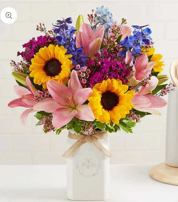 Honey Buzz (extra exquisite) Honey Buzz (extra exquisite) - Get them buzzing with our charming bouquet! A garden-fresh gathering of blooms in sweet shades of yellow, blue, and pink come together for a mix of color and texture. Designed in our Sweet As Can Bee artisanal vase Bloom Details
