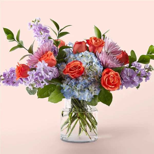 Be Mine Bouquet (exquisite) Be Mine Bouquet (exquisite) - Send the message of love with our Be Mine Bouquet. Inspired by the delightful candy conversations hearts that are so synonymous with the season of sweetness, this arrangement is brimming with voluminous blue hydrangeas, bright pops of orange roses and lavender florals to share just the right sentiment. Please Note: The bouquet pictured reflects our original design for this product. While we always try to follow the color palette, we may replace stems to deliver the freshest bouquet possible, and we may sometimes need to use a different vase. Details The Exquisite Bouquet is about 20" H x 24" W.