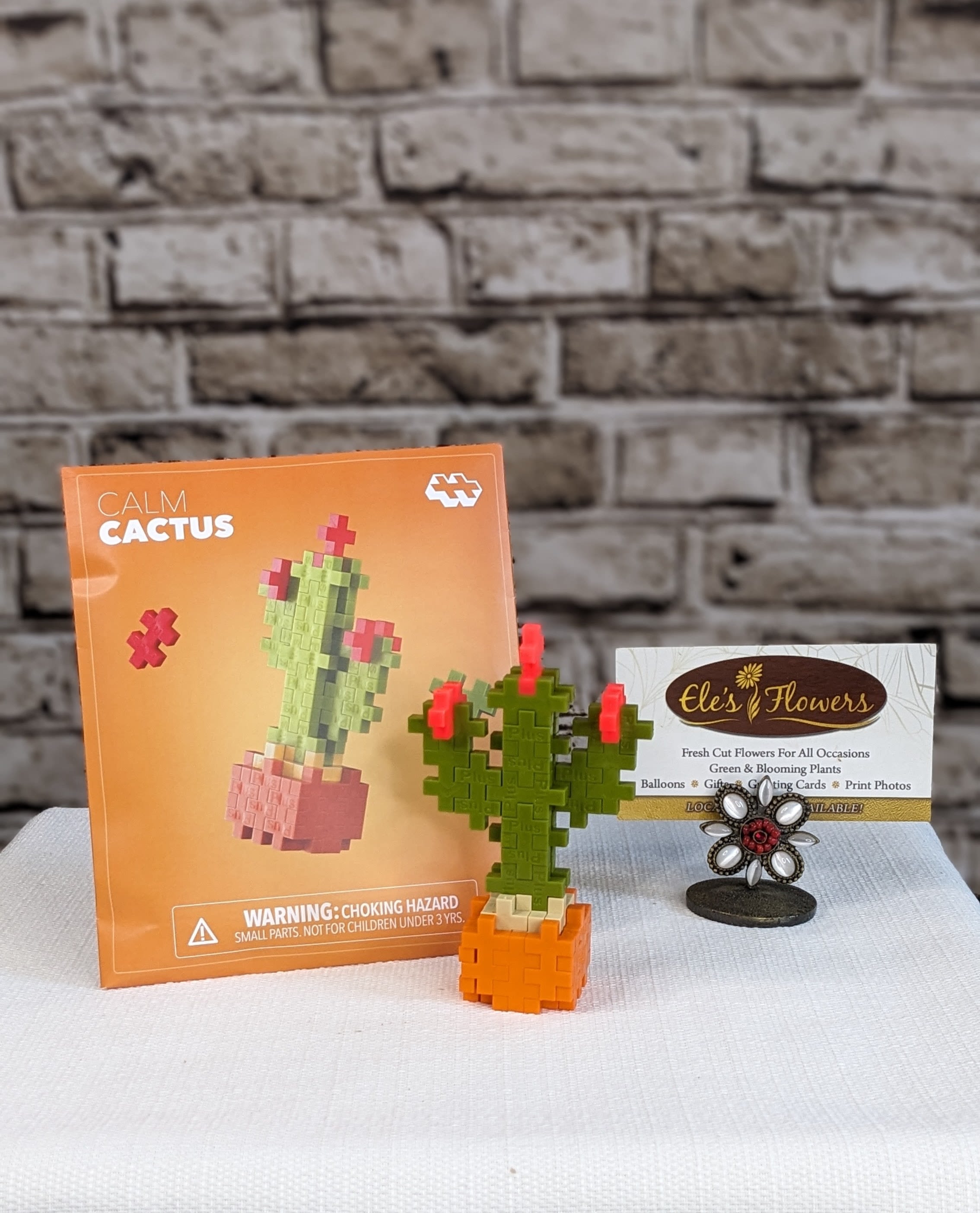 Calm Cactus - Plus Plus - Build your very own mini Calm Cactus in soothing shades of orange, tan, coral, and avocado. This easy, nature‑inspired build is perfect for sparking imaginative play and hands‑on learning.   Packaged like a charming springtime seed packet, it’s perfect for on‑the‑go fun, party favors, or a thoughtful little gift. Each set includes a themed mat so your cactus can sit proudly on display, no watering required, just pure creative joy!