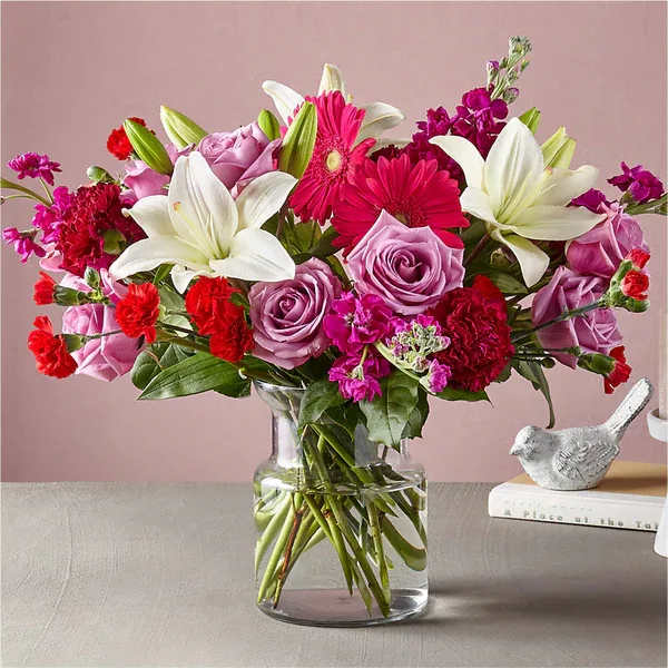 All My Love Bouquet (exquisite) - Give everything and more to the one who captured your heart. The All My Love Bouquet features refreshing pops of color in the hot pink gerbera daisies, while the crisp lilies in a clear, glass vase are effortlessly timeless and elegant.  Please Note: The bouquet pictured reflects our original design for this product. While we always try to follow the color palette, we may replace stems to deliver the freshest bouquet possible, and we may sometimes need to use a different vase. Details The Deluxe Bouquet is about 15&quot; H x 18&quot; W.