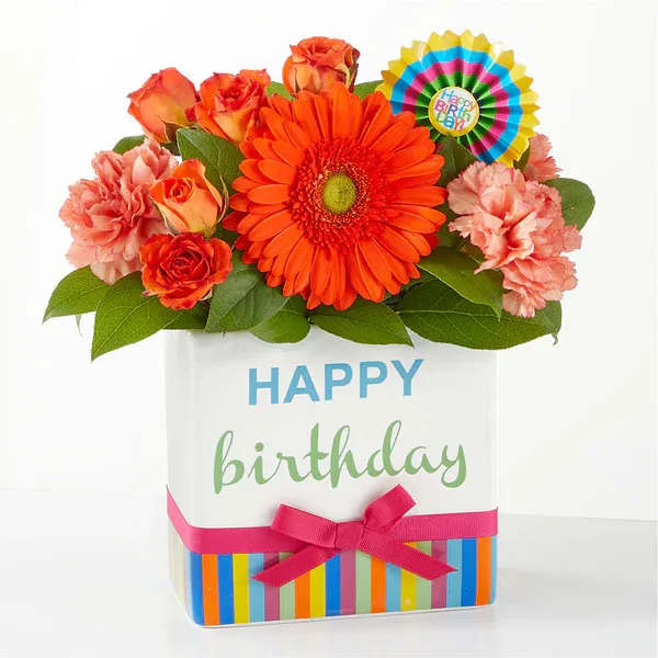 Birthday Surprise Bouquet  - Make their special day unforgettable by surprising them with a gorgeous splash of orange, pink and lavender stems to keep the celebration going all week long. Details The Premium Bouquet is approximately 13&quot;H x 12&quot;W. Designed by florists, ready to display. For long–lasting blooms, add water daily. Pet Safety Precautions: This bouquet or plant may include flowers and foliage that are known to be toxic to pets. To keep them safe, be sure to keep this arrangement out of your pet's reach.