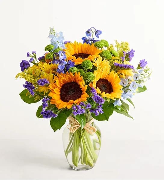 Fields of Europe® Summer - About Fields of Europe® Summer Inspired by the colorful charm of the European countryside, our best-selling summer bouquet is gathered with fresh-picked blooms, revealing the rustic beauty of nature. Shades of golden yellow and rich blue pop against lush greenery, creating a timeless gift for someone special to enjoy.