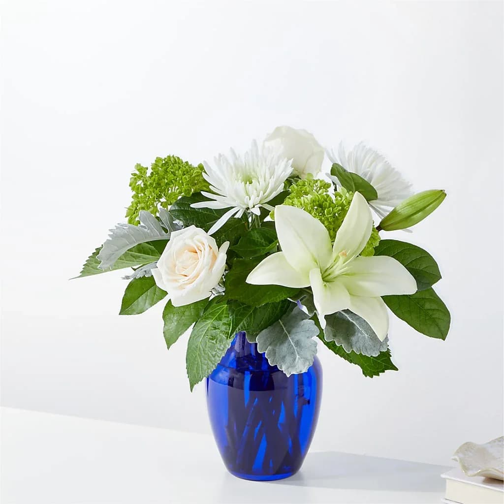Snowy Dreams Bouquet  - Our Snowy Dreams Bouquet is a stunning and elegant floral arrangement that captures the serene beauty of a winter wonderland. Details The Standard Bouquet is approximately 14&quot;H x 15&quot;W. Designed by florists, ready to display. For long–lasting blooms, replace the water daily. We suggest trimming the stems every couple days. Pet Safety Precautions: This bouquet or plant may include flowers and foliage that are known to be toxic to pets. To keep them safe, be sure to keep this arrangement out of your pet's reach.