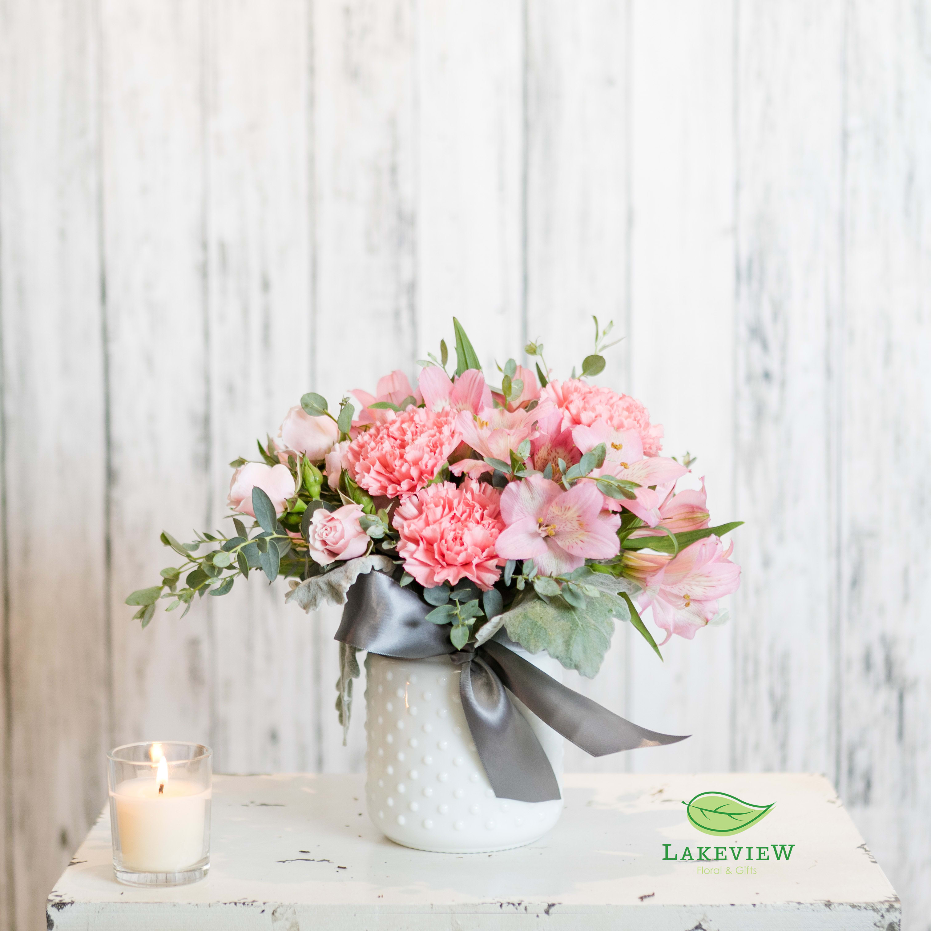 Blush - Send sweet in a vase.  Pastel pink blooms in a vintage white vase are finished with a chic gray ribbon loop.  Approximate Dimensions: 11&quot; H x 9&quot; W