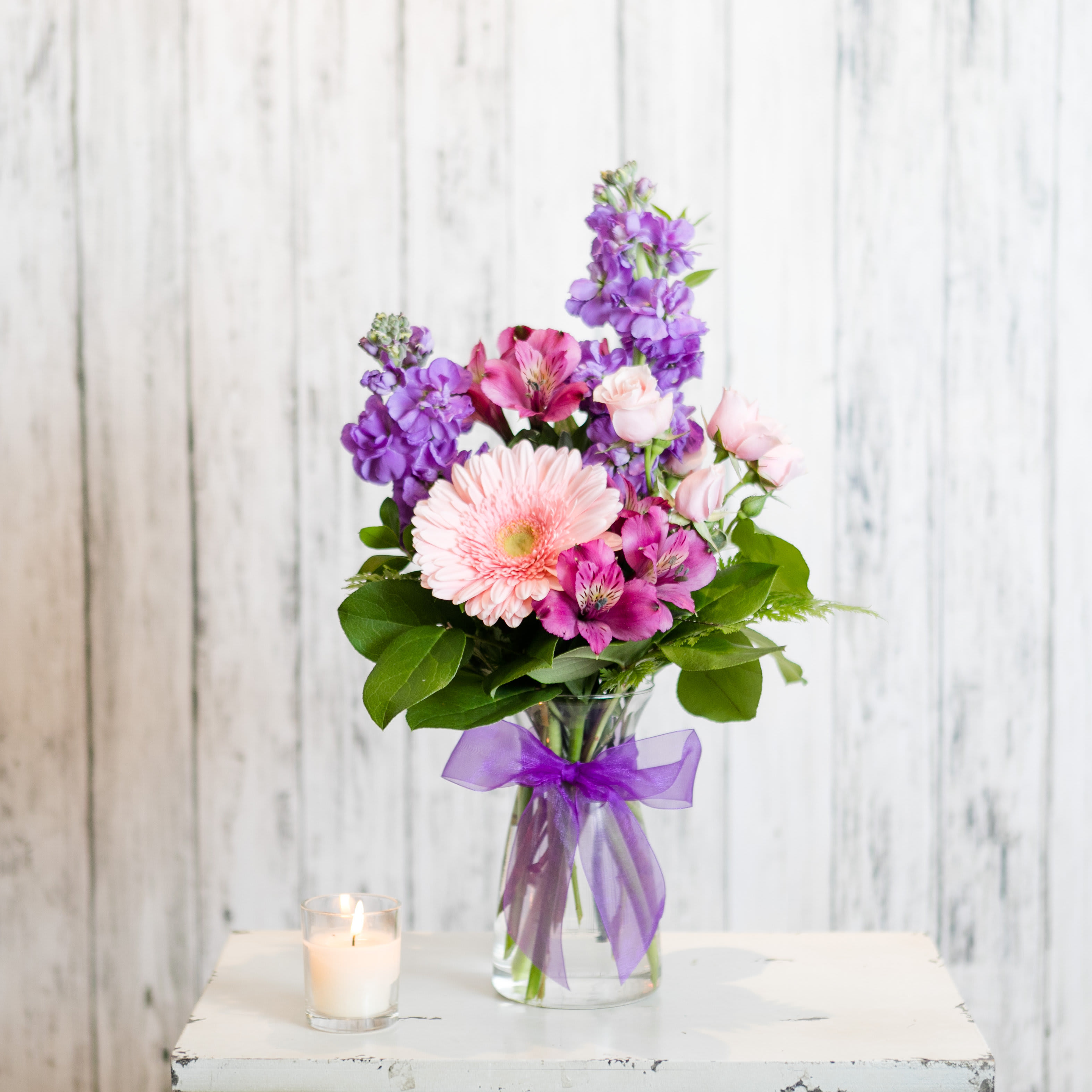 Charm Charm - Send caring thoughts with a feminine combination of pink and lavender tied with a simply sweet bow. Approximate Dimensions: 17" H x 8" W