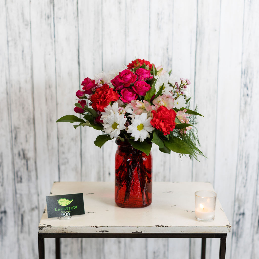 Darlin' - Reminiscent of a romantic wildflower bouquet, this arrangement features daisies, spray roses and alstroemeria in traditional romantic colors.  Approximate Dimensions: 14&quot; H x 11&quot; W