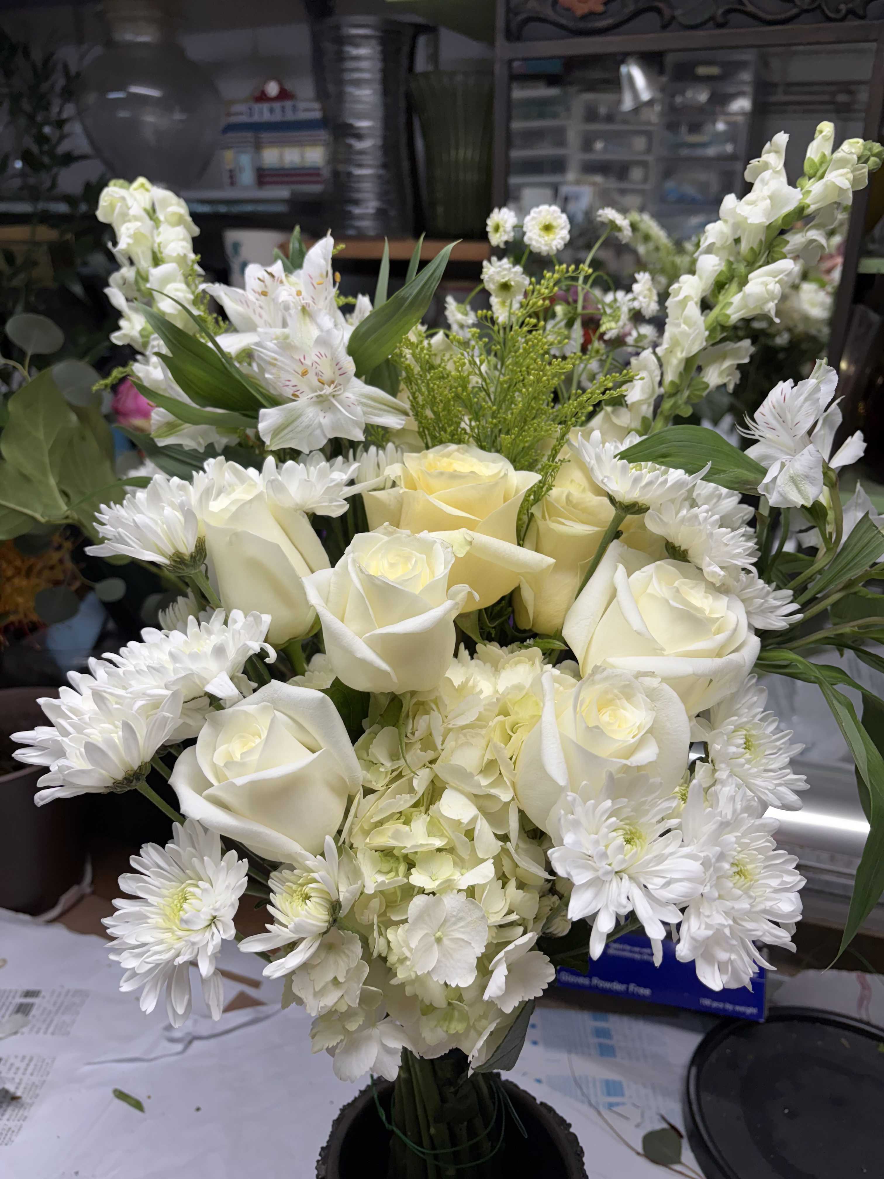 Peaceful White Sympathy Vase Peaceful White Sympathy Vase - Convey your heartfelt sympathy with this elegant white floral arrangement in a classic vase. Featuring creamy white roses, chrysanthemums, hydrangeas, and snapdragons, this design brings a calming presence to any memorial service or home. Perfect for expressing peace, respect, and eternal remembrance.   Includes: White roses, white chrysanthemums, white hydrangeas, snapdragons, seasonal filler greens  Size: Approx. 16–20 inches tall  Ideal for sympathy delivery to homes, funeral homes, or memorial venues in San Francisco area