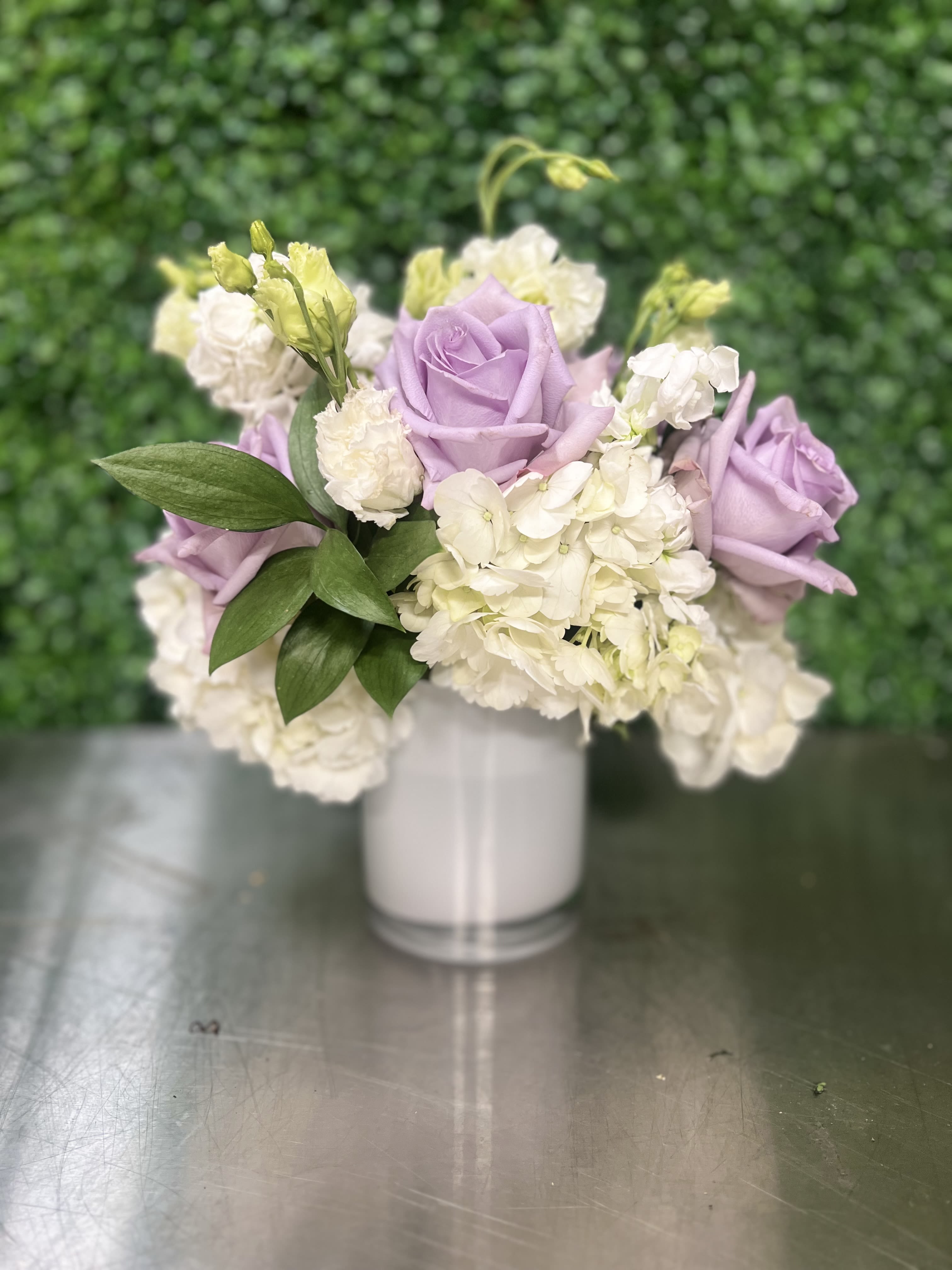 Pop of Lavender by BloomNation™ - Our most popular arrangement! Pop of Lavender by BloomNation™ is the perfect gift to wish someone a happy birthday or to say thank you.   Arrangement Details: Includes cymbidium orchids, lavender roses, and white hydrangea.  APPROXIMATE DIMENSIONS:10&quot; H X 11&quot; W X 11&quot;L