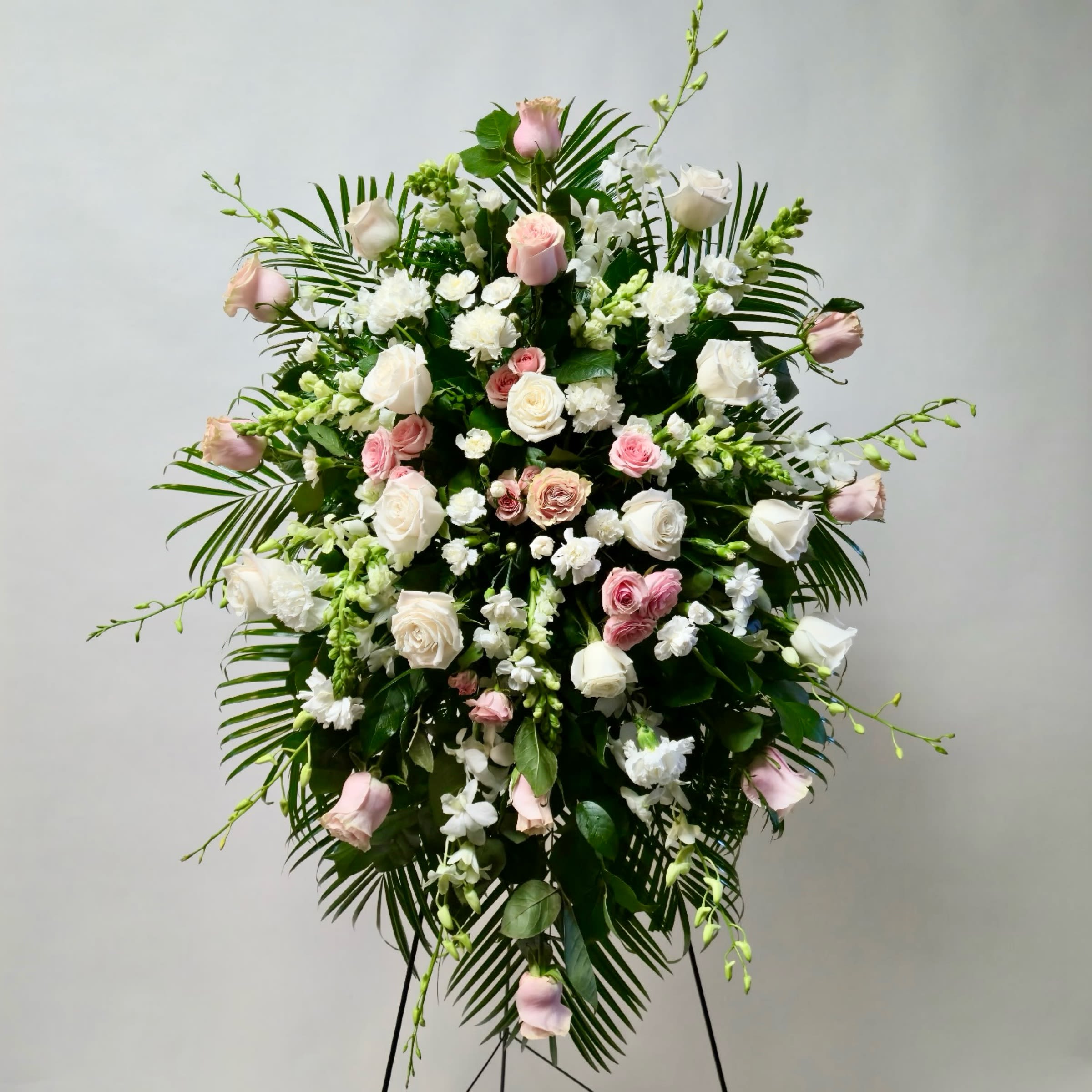 Blushing Farewell Standing Spray - This Standing Spray Includes White Dendrobium Orchids, Light Pink Spray Rose, Light Pink Rose, White Rose, White Snapdragon and White Mini Carnation. Or as Similar as Possible. 