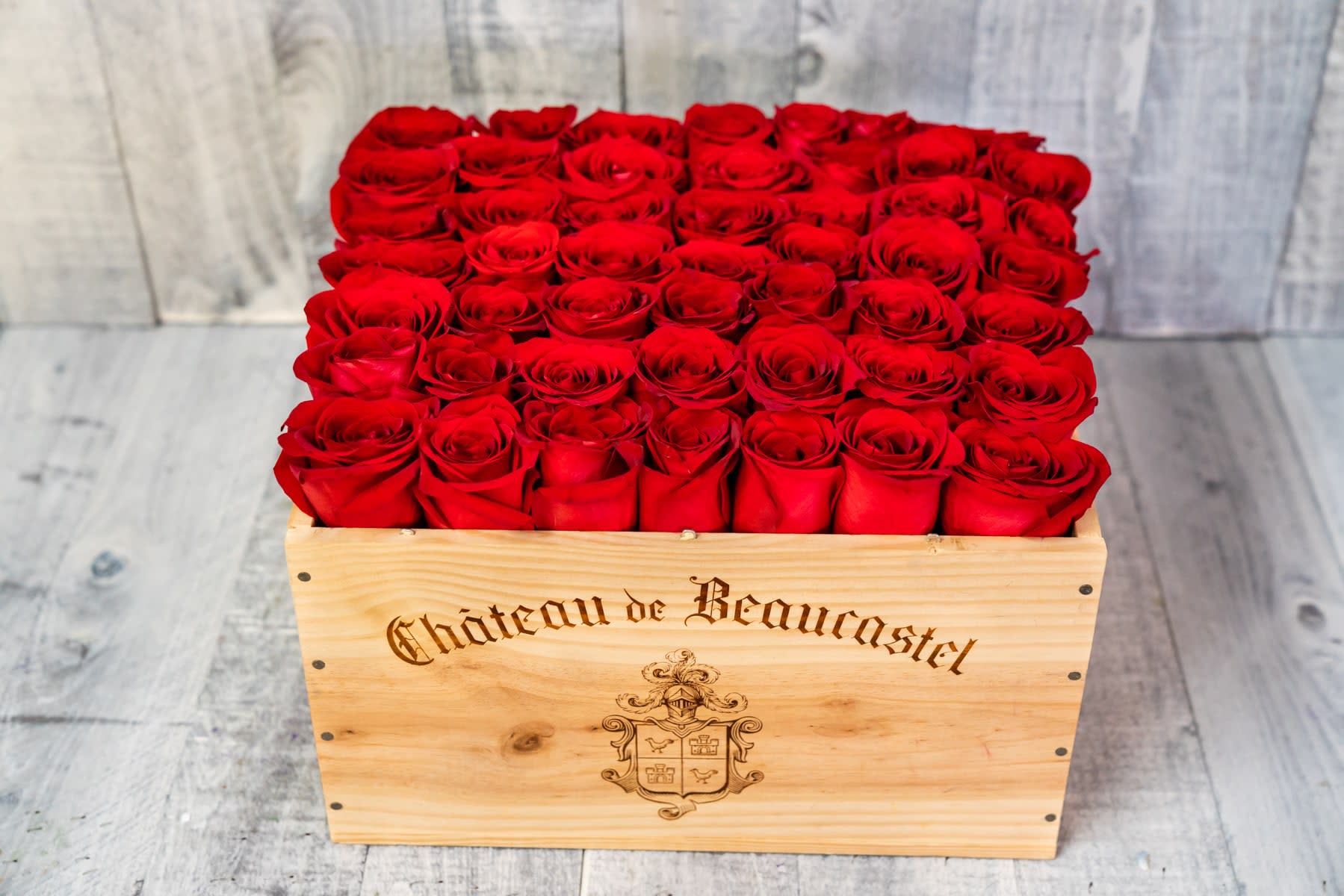 50 Premium Roses in Valley Village - A handcrafted wooden wine box featuring 50 of the highest quality Ecuadorian Roses, available in the color of your choice. Choose Deluxe for 75 steams or Premium for 100 stems.