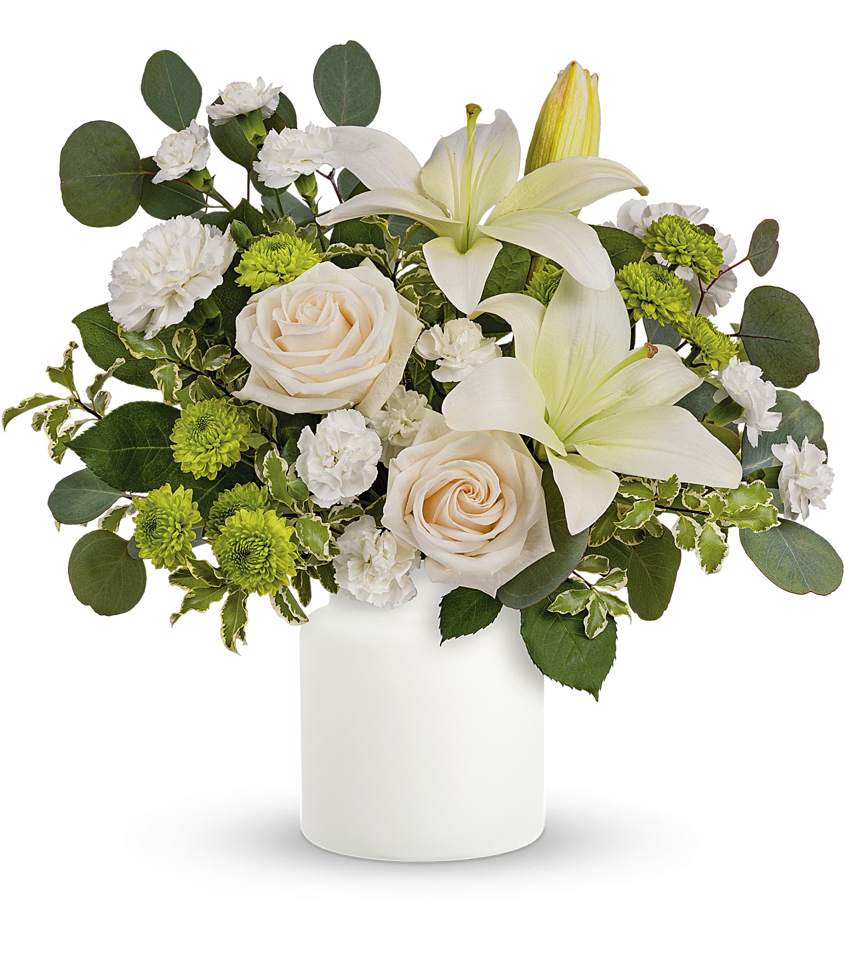 Eternally Elegant - This ethereal arrangement is a calming, peaceful gesture that shows them you care. Elegant white blooms accompany a timeless matte white vase. Roses, white lilies and carnations are accented with leaves of fragrant and calming eucalyptus in a timeless matte white vase. Approximately 16 1/2&quot; W x 16&quot; H TEV62-5A