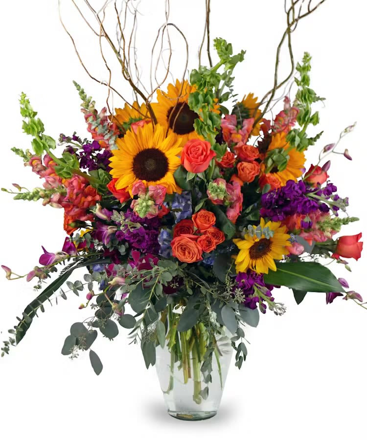Just Thinking of you - “Add a burst of color to your day with this gorgeous floral arrangement!  Vibrant sunflowers, rich roses, and bold purple accents come together with lush greenery to create a breathtaking display. Perfect for celebrating special moments or simply spreading joy. 