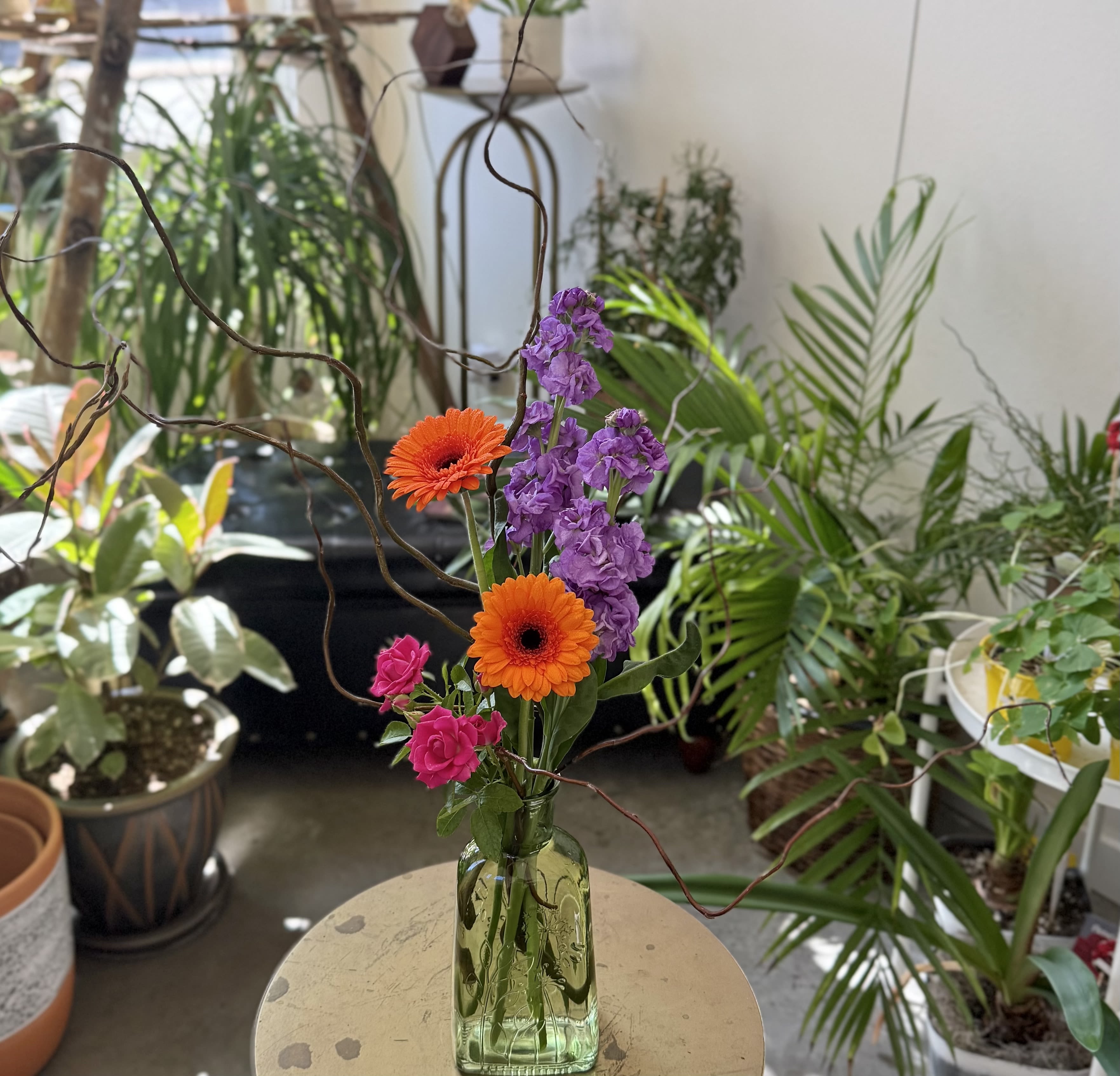 Emerge - A lovely embossed glass vase exploding with branches, from which emerge beautiful MN grown blooms.