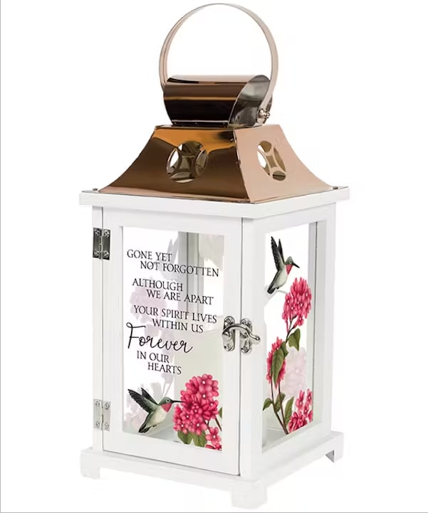 Memorial Lantern - Hummingbird Memorial Lantern - Hummingbird - Beautiful memorial lantern with hand painted look of hummingbirds.. as well as the "Gone yet not forgotten, Although we are apart, Your spirit lives within us, Forever in our hearts." Made of wood, glass and reflective coppered metal. "13.5x6.25 This lantern includes a flickering battery operated candle. It will be hand delivered turned on and with your sentiment on a printed card.