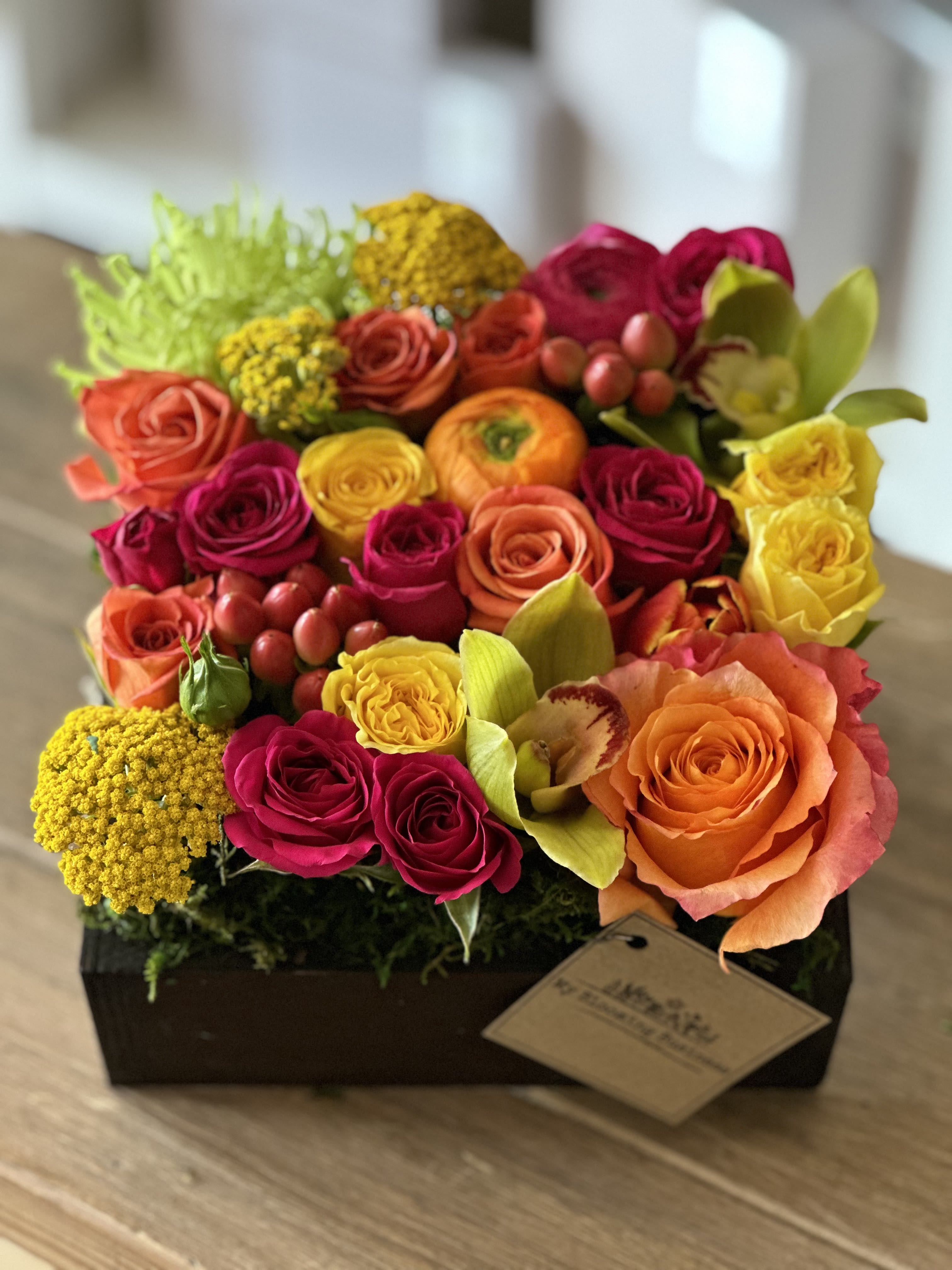 Fairy Tail Fairy Tail - Once upon a time, in a world filled with boring floral arrangements, there came a box of blooms that was anything but ordinary. Ladies and gentlemen, gather 'round and let me introduce you to the marvelous Fairy Tale! Box is 7"L x7"W x3"H (picture shows premium size) Arrangement is approximately 9" high Blooms: roses, spray roses, tulips, freesias, cymbidium orchids, dianthus, clover, ranunculus, SAME DAY DELIVERY: All Deliveries are between 9:00am to 5:00pm and cannot guarantee an exact time of delivery. We do offer express delivery if you do need it by a certain time. Some areas may be excluded check with our shop for details.