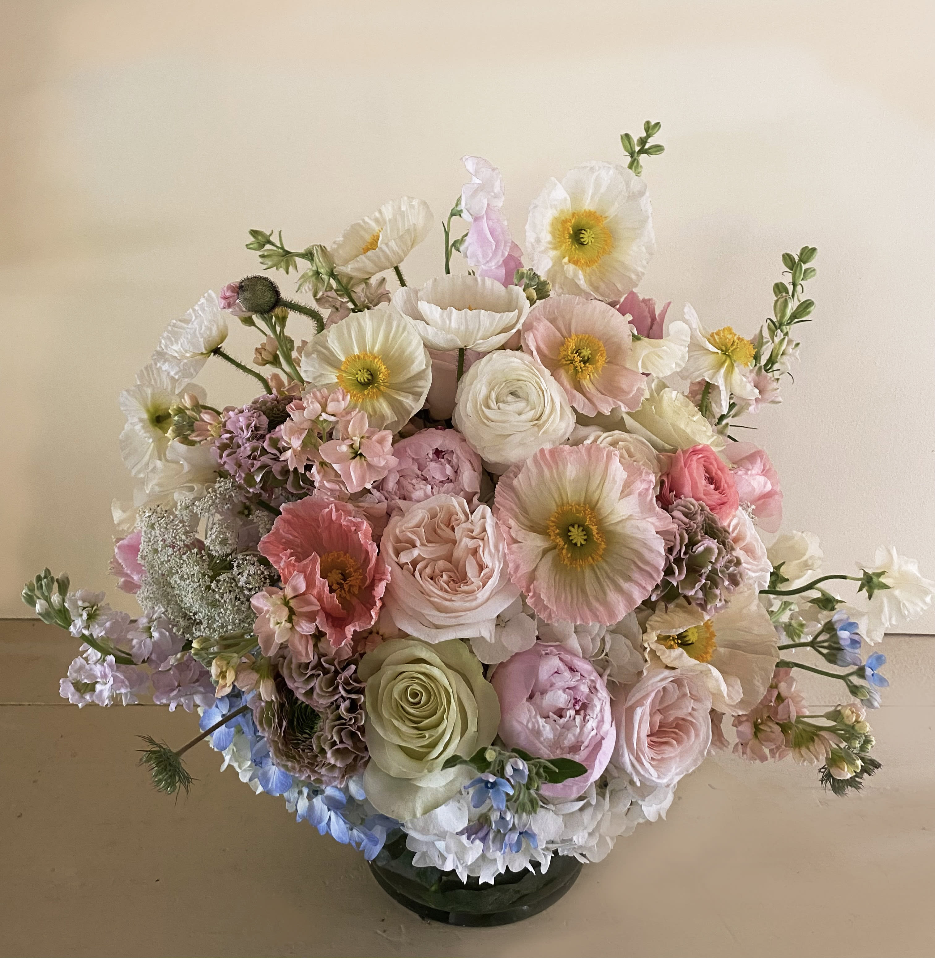 Rosalie arrangement Rosalie arrangement - Breathtaking poetic pastel arrangement size L to swoon and be adored. Perfect for the mother of love, the hostess, birthday person or other. Made full of eclectic stems like poppies, wild flowers, peonies, dahlias, roses, sweetpeas and other gorgeous fresh stems arranged in a clear vase (6 by 6"), go Deluxe for more stems in same sized vase or Premium for a larger vase with even more stems.