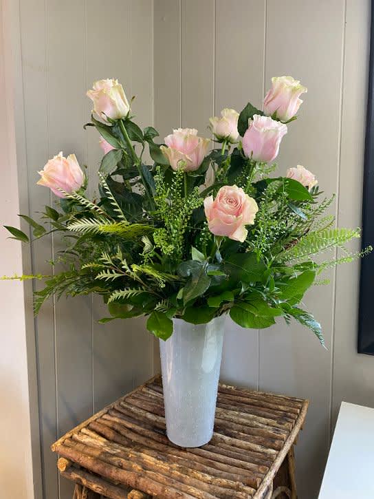 Pink Dozen Roses Coleen's Style Pink Dozen Roses Coleen's Style - A dozen premium pink roses arranged with flat seeded eucalyptus, spiral eucalyptud ahd lush greens.