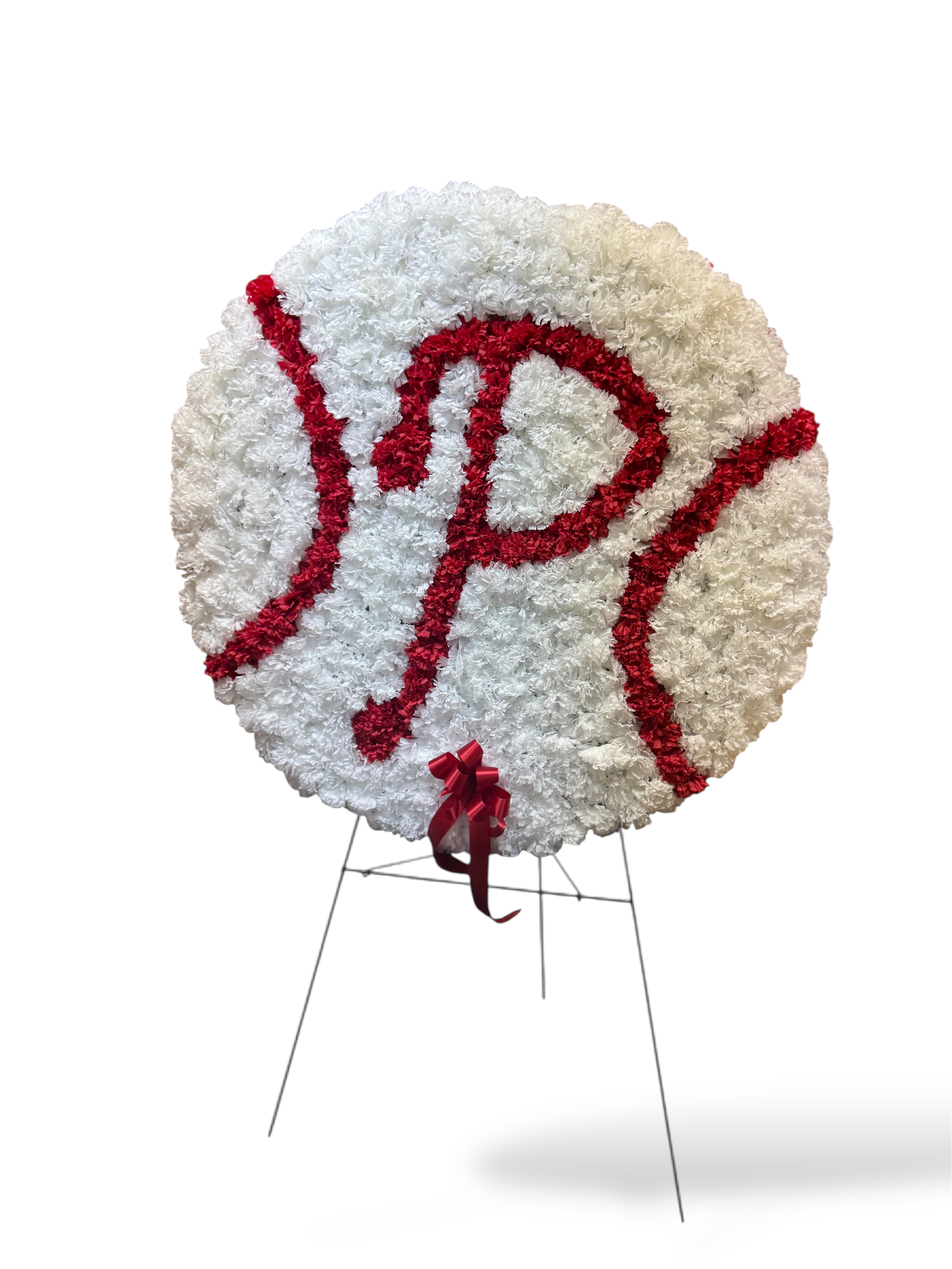 Philly Farewell Tribute Philly Farewell Tribute - Honor the memory of a devoted Philly fan with this lasting baseball-themed sympathy piece. Crafted entirely from high-quality permanent botanicals, the design features a round baseball shape with crisp white blooms and vibrant red accents forming the iconic Philly “P” and stitching. Built to withstand the elements, this tribute is designed to remain at the gravesite as a long-lasting symbol of love, remembrance, and team spirit. Finished with a coordinating red bow, it’s a thoughtful way to celebrate both their life and their love for Philadelphia baseball.
