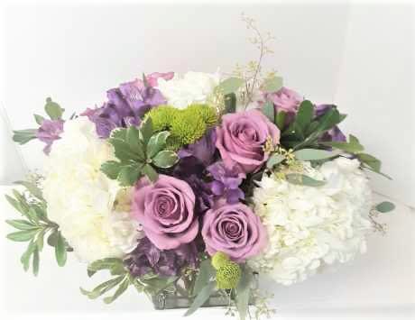 Vintage style centerpiece - Hydrangeas, 6 Roses, Alstromeria and more in an oblong style, in a large modern clear cube ,perfect for any celebration!