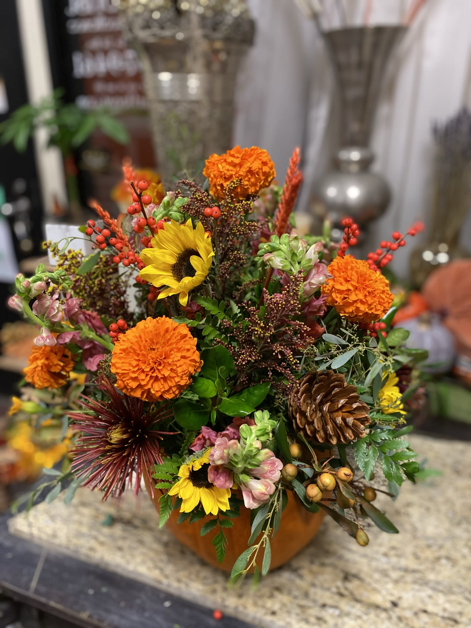 Splendid pumpkin  - A fall collection of lush browns oranges and seasonal blooms arranged in a fresh large pumkin