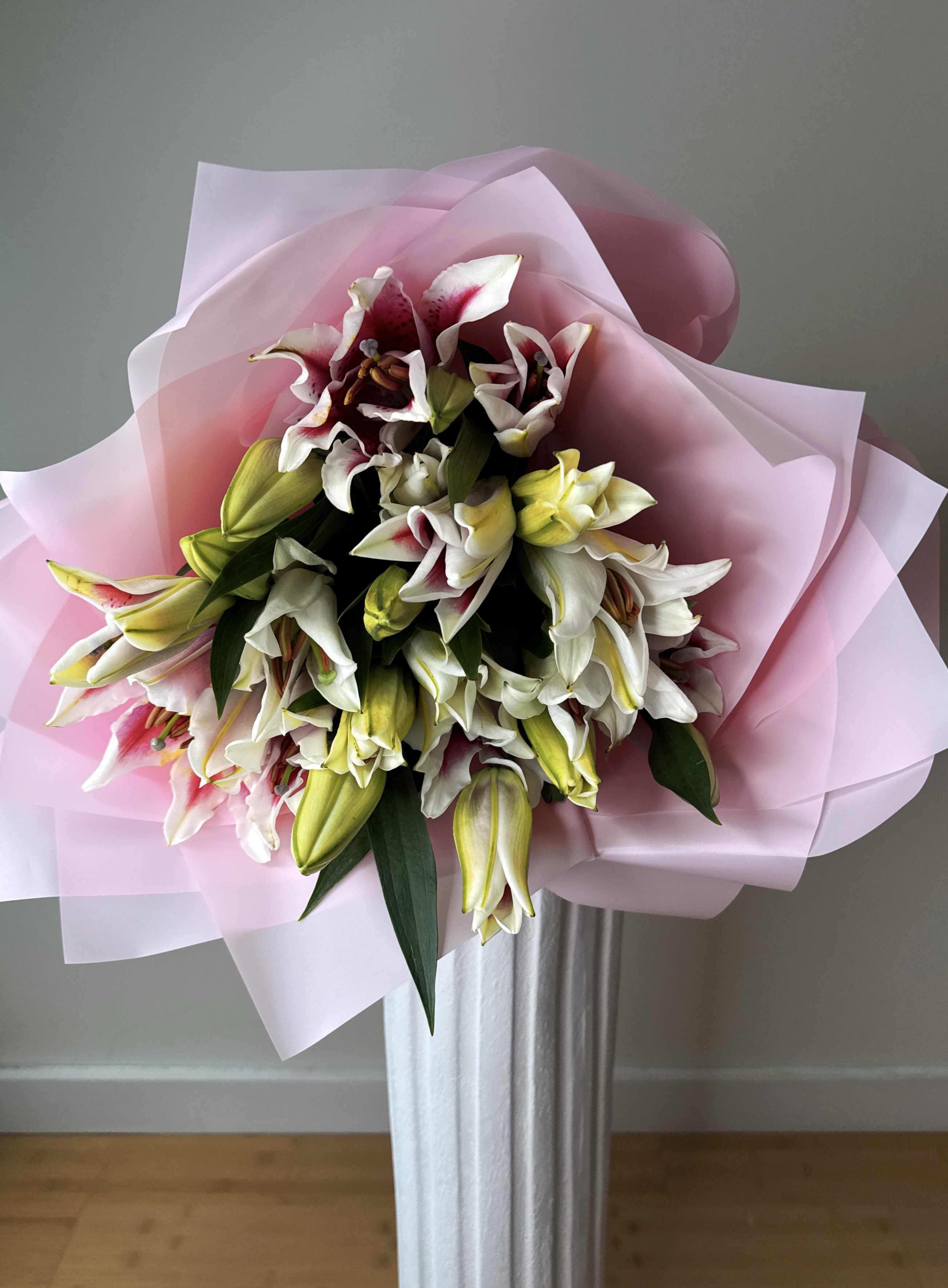 Premium Lily Bouquet - A stunning arrangement of majestic, fragrant oriental lilies, elegantly wrapped in delicate pink paper to enhance their natural beauty.  Delivered with blooms closed or partially open, allowing you to enjoy their gradual blossoming and extend their freshness for as long as possible.  Each stem is carefully selected to ensure elegance, fragrance, and an impeccable presentation the signature of Flevoland Flowers.