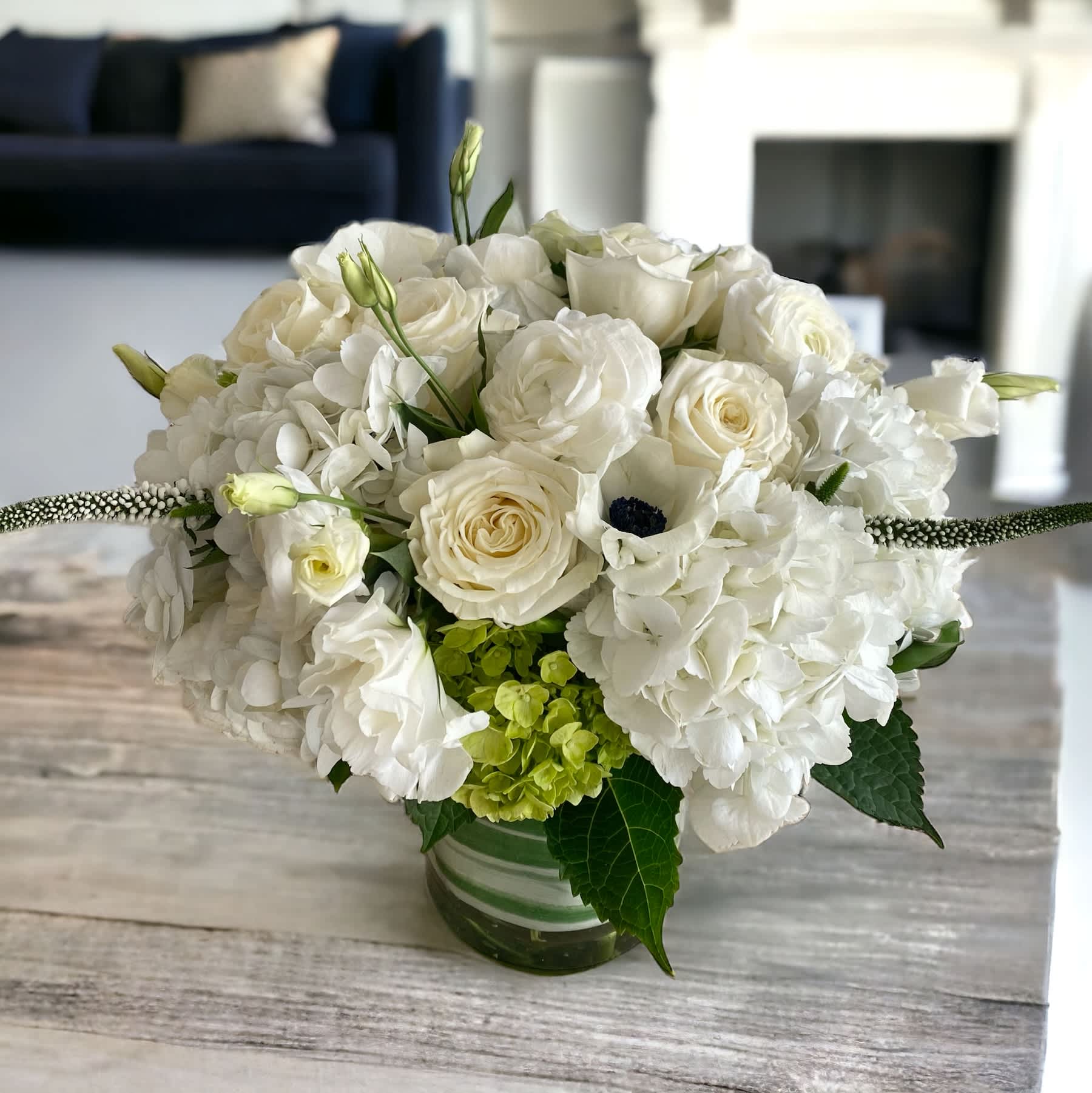 Pure White  - Pure, serene and comforting. Designed and hand-crafted with a variety of seasonal, fresh, high-end flowers in a white color palette. Container is a 6&quot; glass or ceramic white vase. Pictures are not exact duplicates of what we will be making, but rather are samples of our creations and design style. However we will make every effort to stock and use flowers shown. arrangements will be DESIGNERS CHOICE based on flower availability in the particular COLOR PALETTE you are choosing. For same day delivery, call us at 949-682-5004.