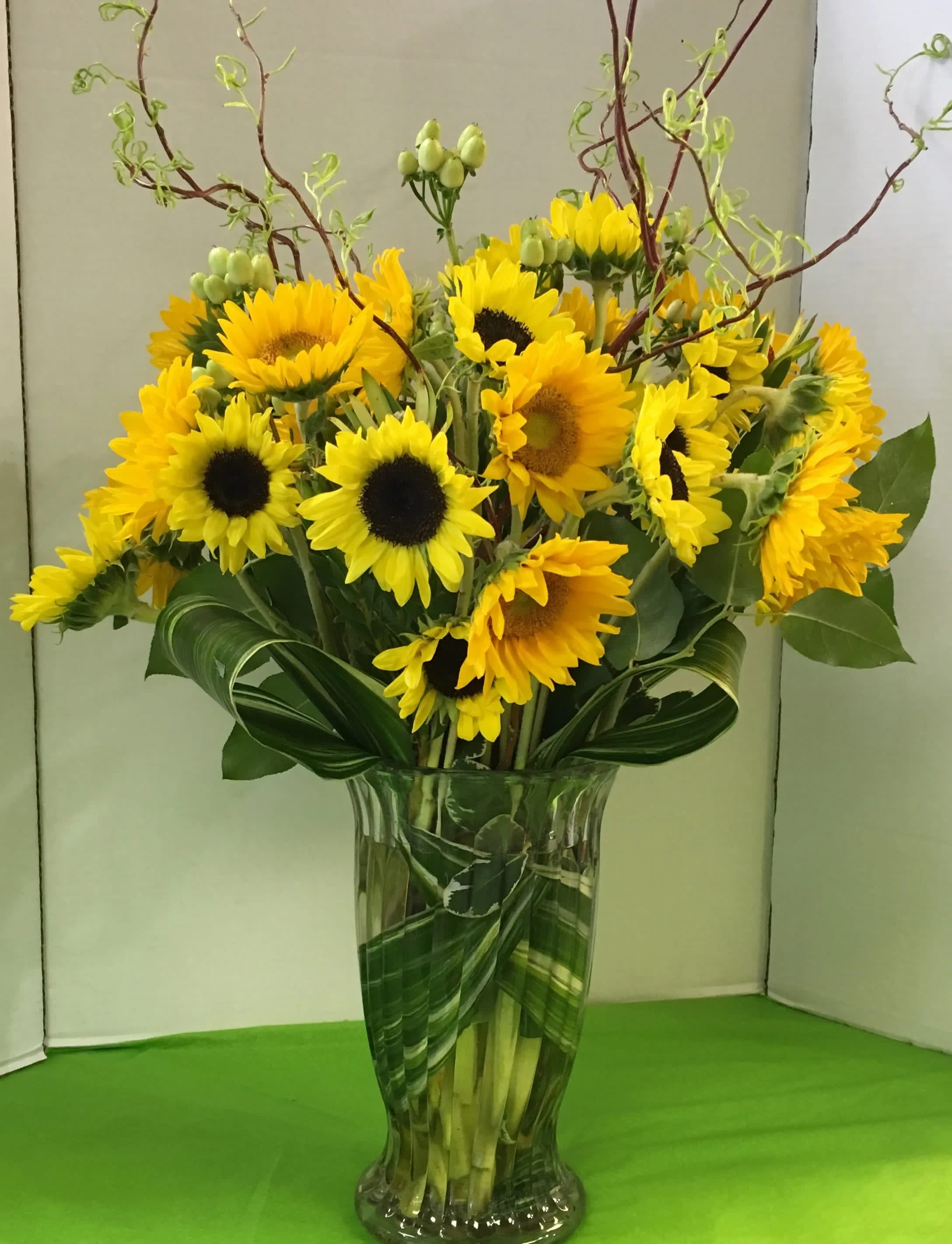 Sunflower  Arrangement (Picture is Deluxe) - Sunflowers, Assorted Summer Flowers, Fancy Greens.  Note:   There are a variety of Sunflowers.  We cannot guarantee  which variety will be available.