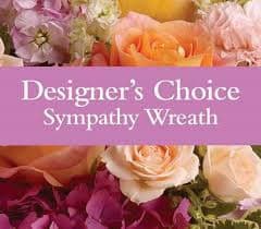 Designer's Choice Sympathy Wreath Designer's Choice Sympathy Wreath - A Designer's choice of flowers and greenery added to a 18" wreath and attached to a metal easel for ease in viewing.