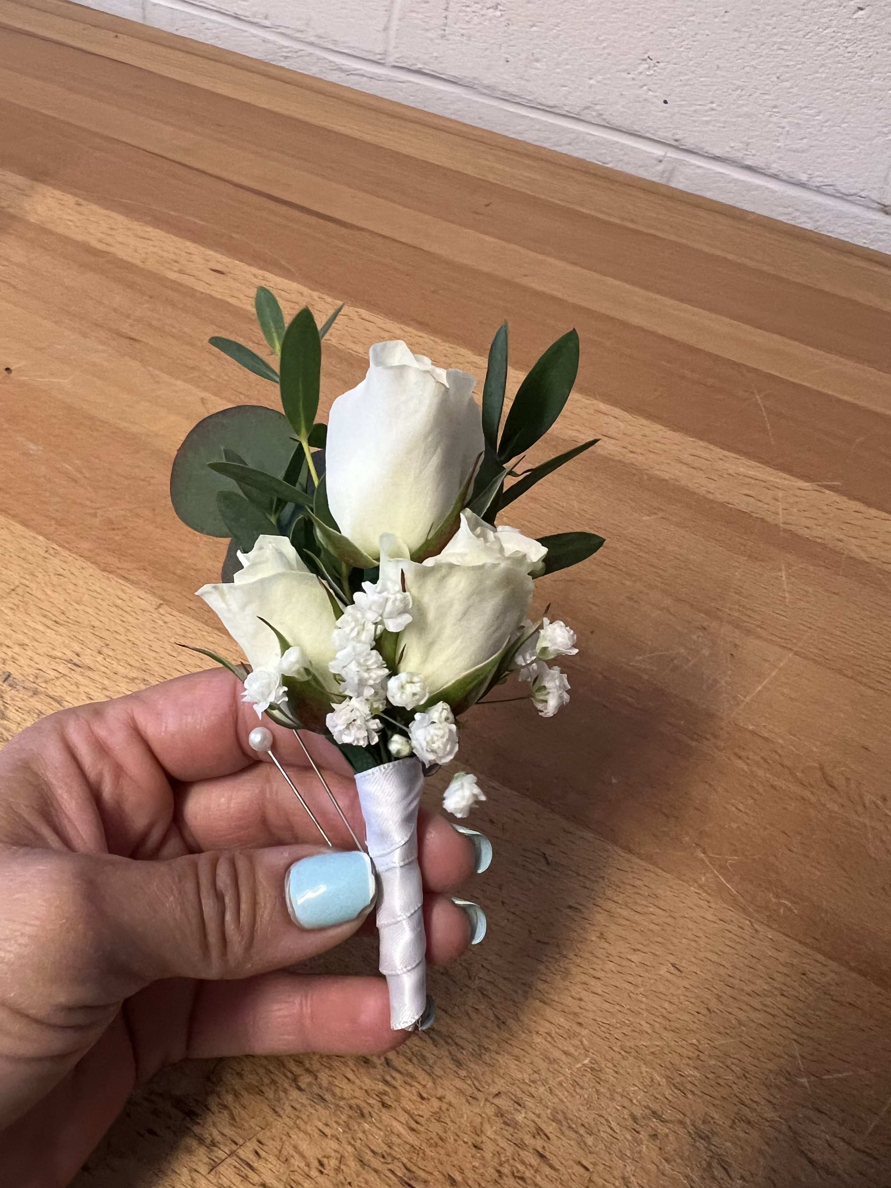 Classic Touch - Simple yet timeless boutonniere with white spray rose and subtle accents.