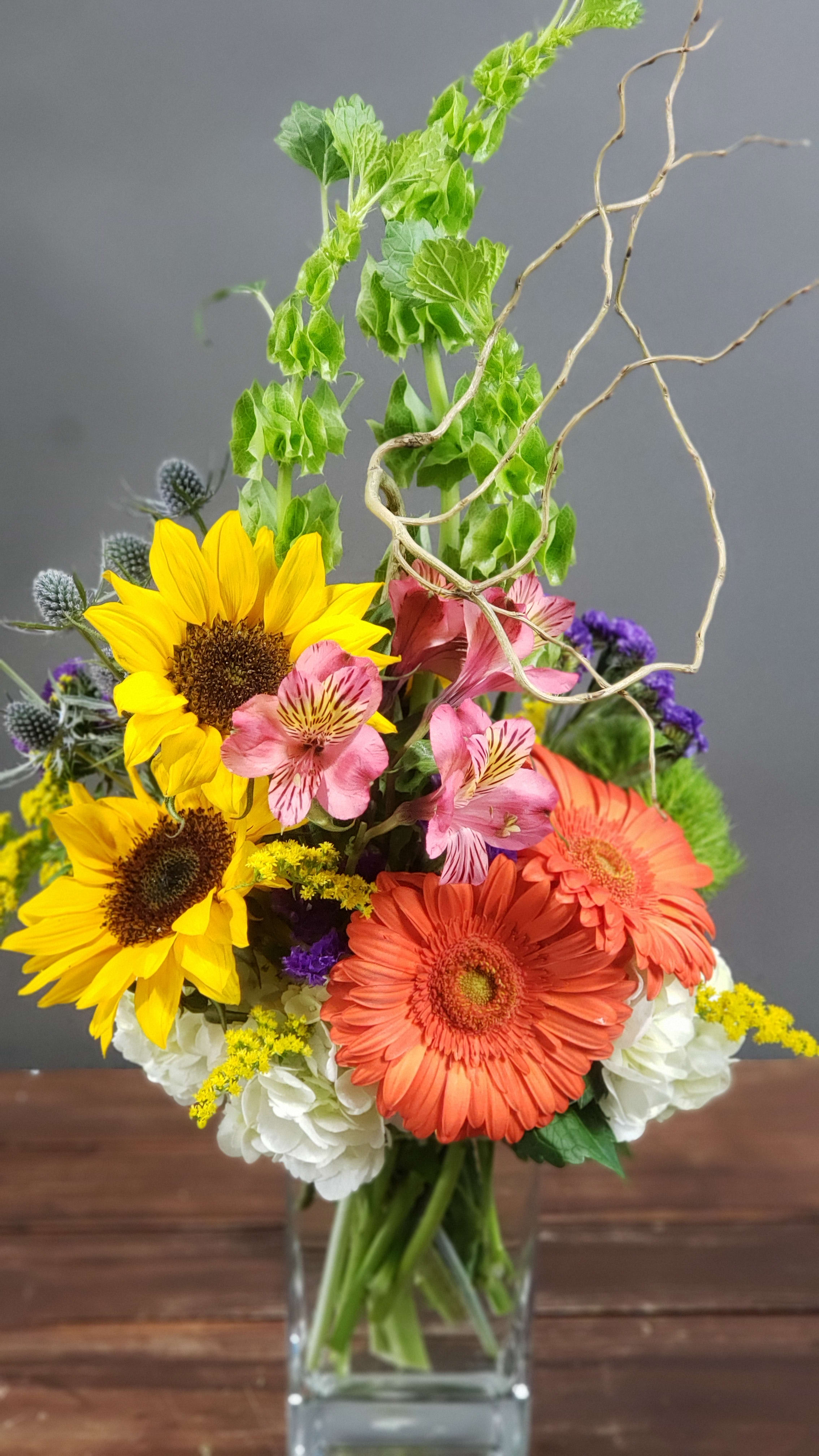 Reach For The Sky - Fun twist with sunflowers in a glass vase.